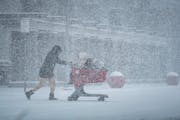 Shoppers braved the blowing snow heading to the Target parking lot, Tuesday, Feb. 22, 2022, Apple Valley, Heavy snow fell in the Twin Cities Tuesday. 