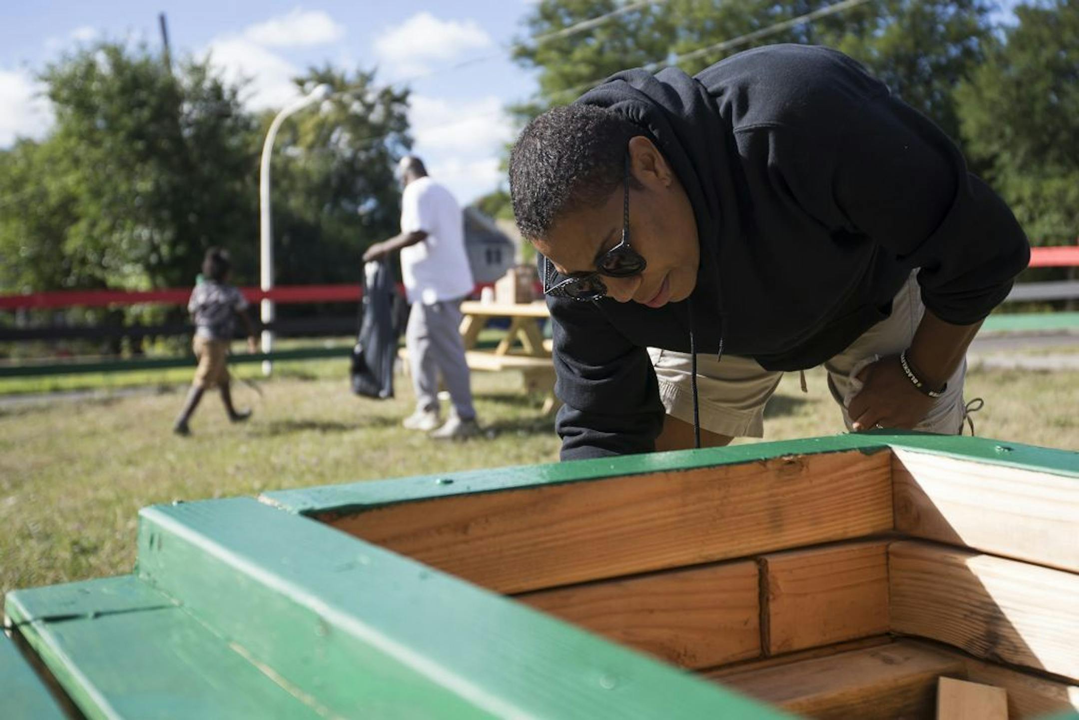 Asiaha Butler, executive director of the Resident Association of Greater Englewood, paints flower boxes Sept. 30, 2017, on a vacant lot in Chicago's Englewood neighborhood. In 2019, Butler called an analysis of life expectancy gaps in Chicago alarming but not surprising.