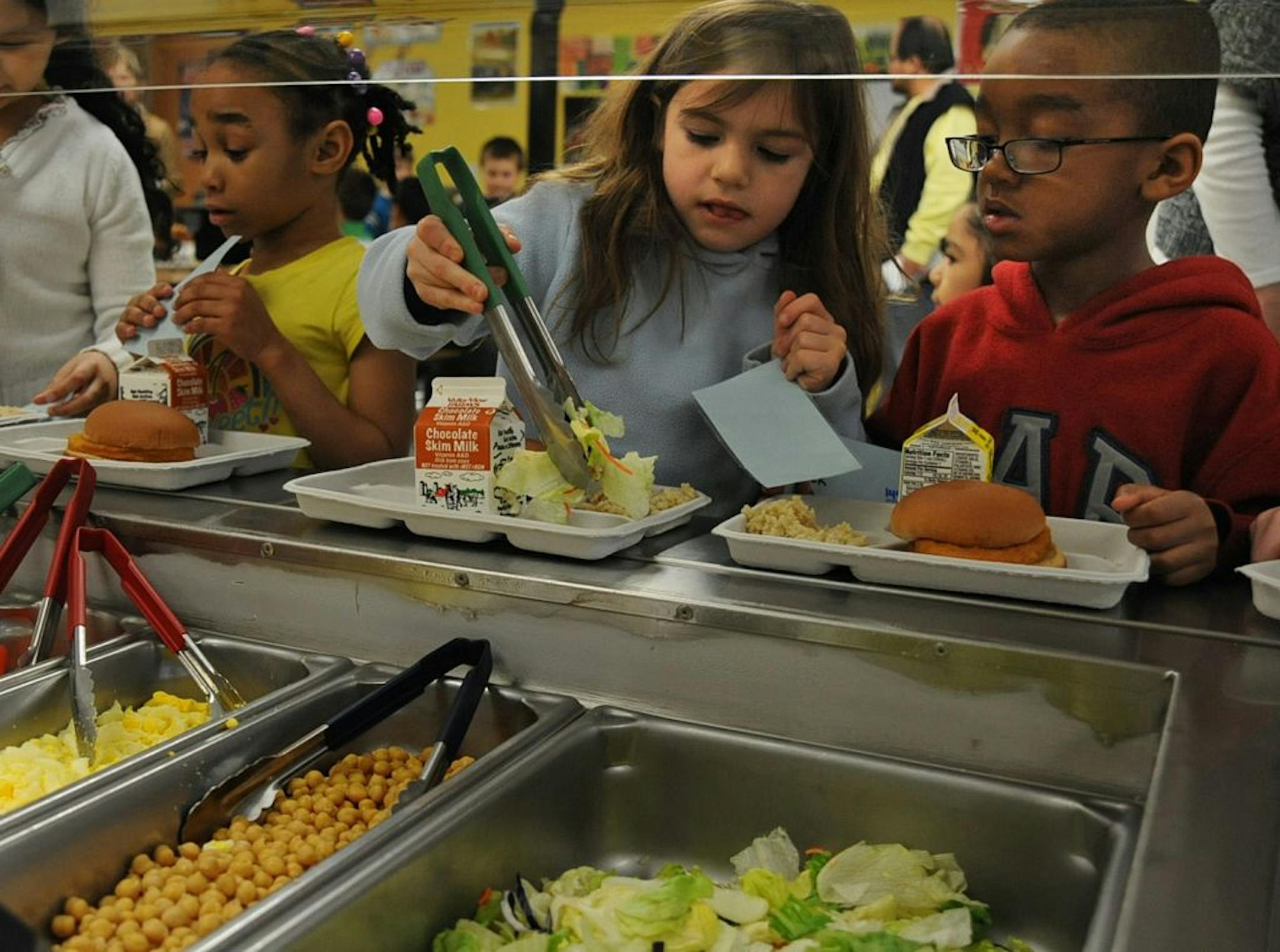 Garlough Magnet School in West St Paul, Minn. is one of five elementary schools in the district that now has salad bars, aimed at giving kids healthier food. Grace Paschka, 6 years old loads her plate with salad with Julina Evon Cepeda 7 years old , on the left and 6 year old Tevyon Block, on the right.
