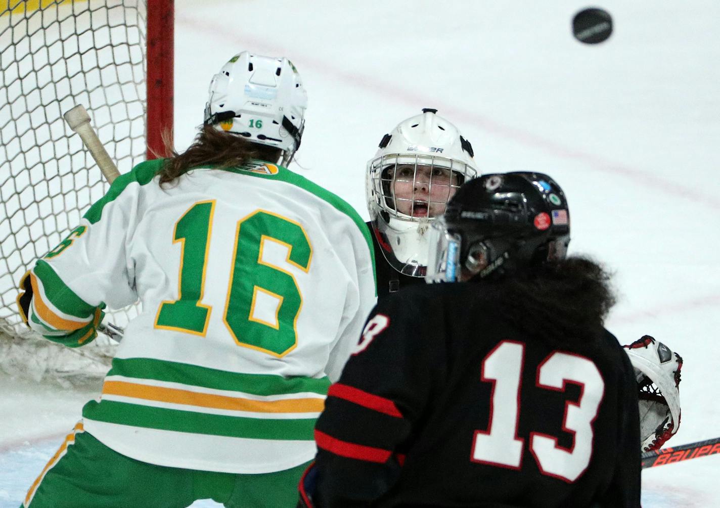 Eden Prairie goaltender Alexa Dobchuk (30) watched as the puck went over the head of her teammate Crystalyn Hengler (13) and Edina's Emily Oden (16) during the first period. ] ANTHONY SOUFFLE &#x2022; anthony.souffle@startribune.com Players competed in the Class 2A girls' hockey state semifinals Friday, Feb. 24, 2017 at the Xcel Energy Center in St. Paul, Minn.