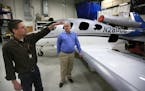 Patrick Bergen, left, Cirrus Aircraft&#x2019;s lead airframe engineer, and Doug Griswold, vice president for the Vision SF50 program, near the SF50 te