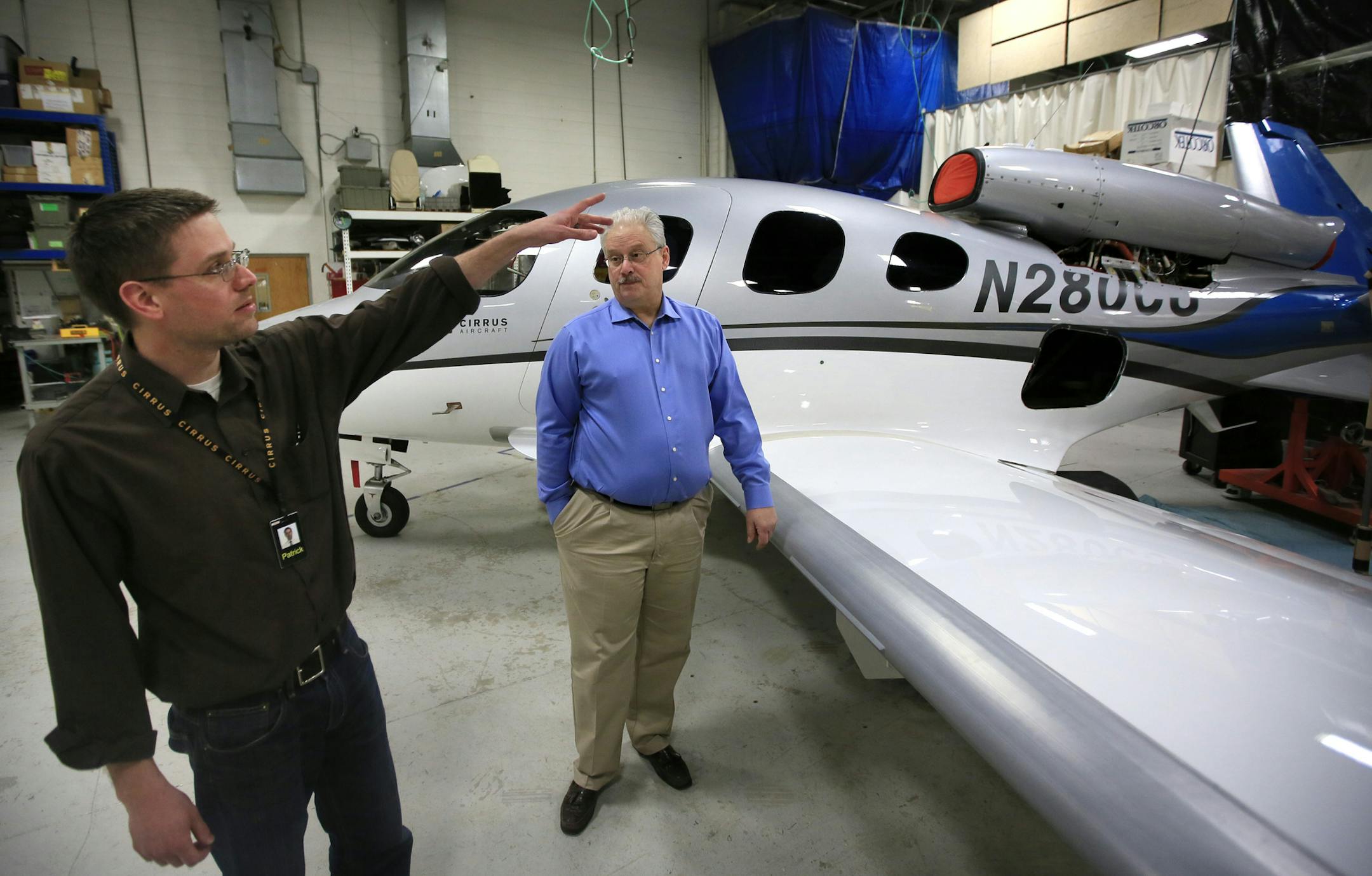 Patrick Bergen, left, Cirrus Aircraft&#x2019;s lead airframe engineer, and Doug Griswold, vice president for the Vision SF50 program, near the SF50 test jet in Duluth.