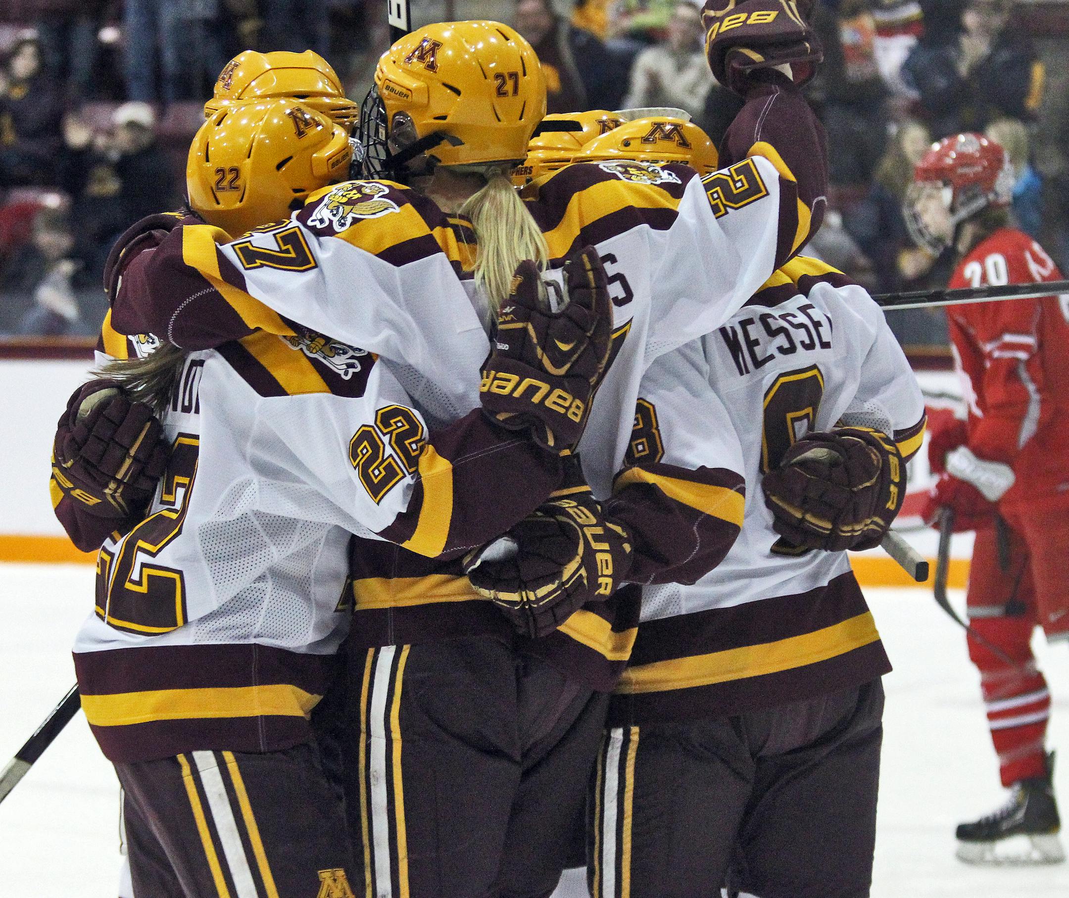 WCHA WOMEN'S HOCKEY PLAYOFFS - Minnesota vs. Ohio State. Gophers players celebrated a first period goal as Ohio State's Kari Schmitt (20) skated away. (MARLIN LEVISON/STARTRIBUNE(mlevison@startribune.com (cq -PROGRAM)