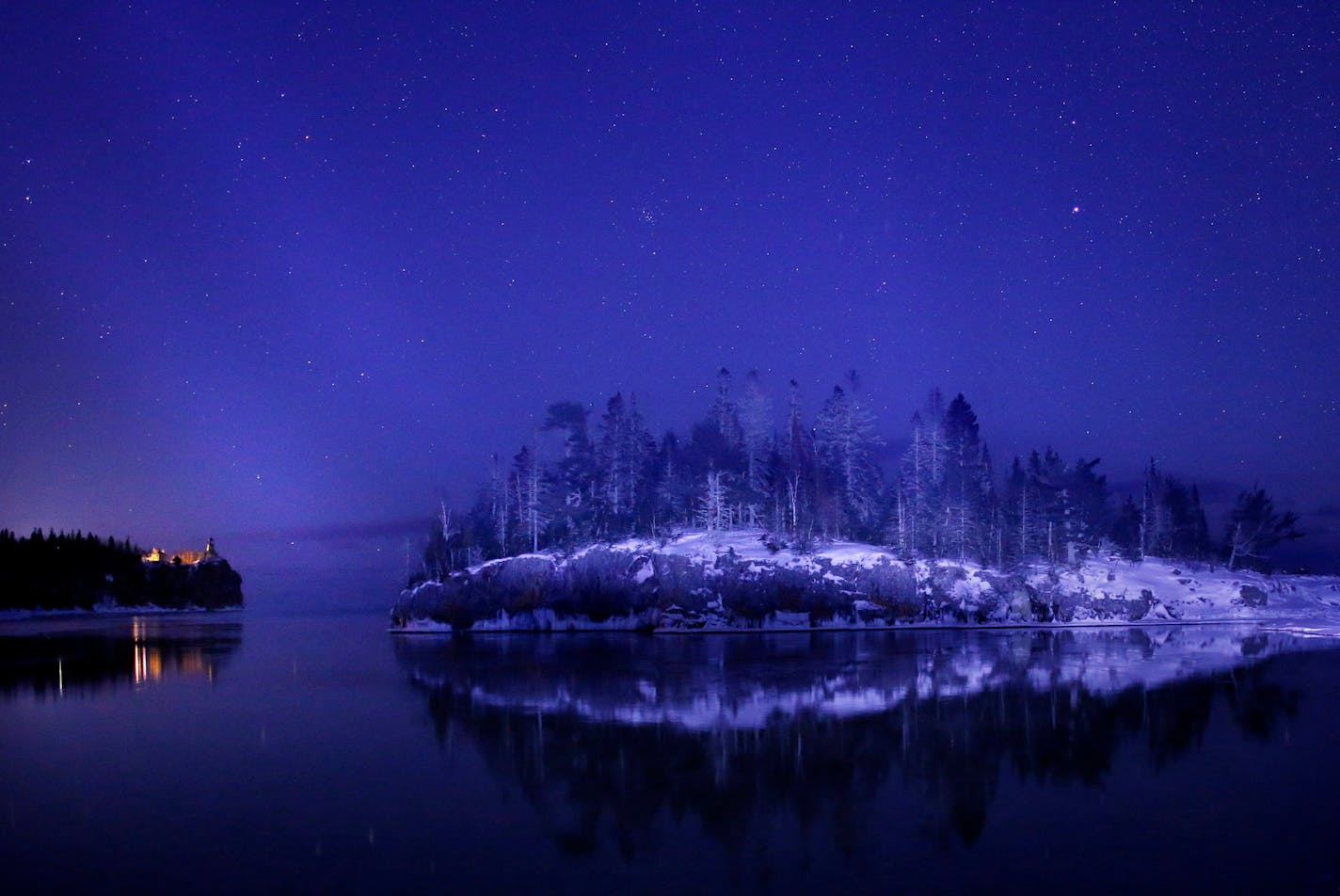 Split Rock Ligthhouse (left) and Ellingson Island aglow in the twilight of a cold winter evening.