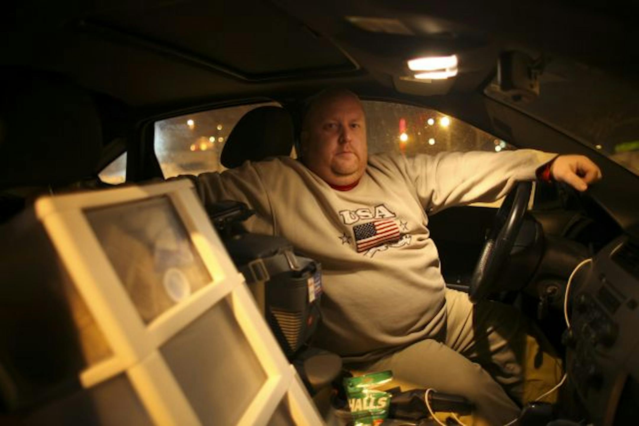 Greg Staffa has outfitted his 2008 Ford Focus with a small cooler and heater that run off the car's battery. He was killing time Monday night in the parking lot of an Apple Valley shopping center and wasn't sure where he'd park for the night.