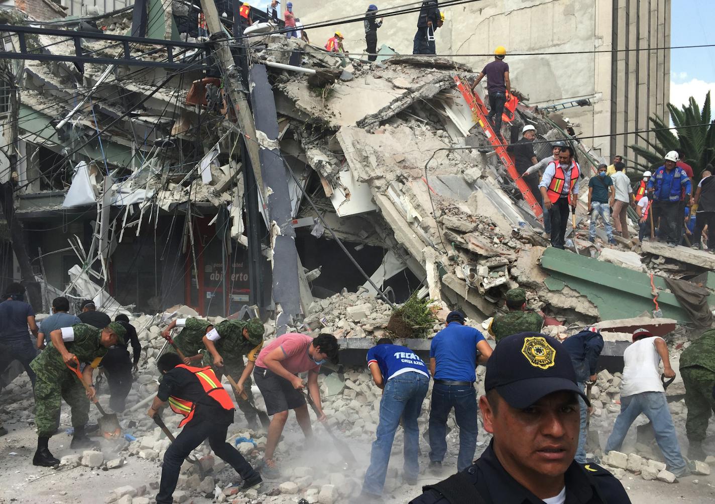 People search for survivors in a collapsed building in the Roma neighborhood of Mexico City, Tuesday, Sept. 19, 2017. A powerful earthquake has jolted Mexico, causing buildings to sway sickeningly in the capital on the anniversary of a 1985 quake that did major damage.