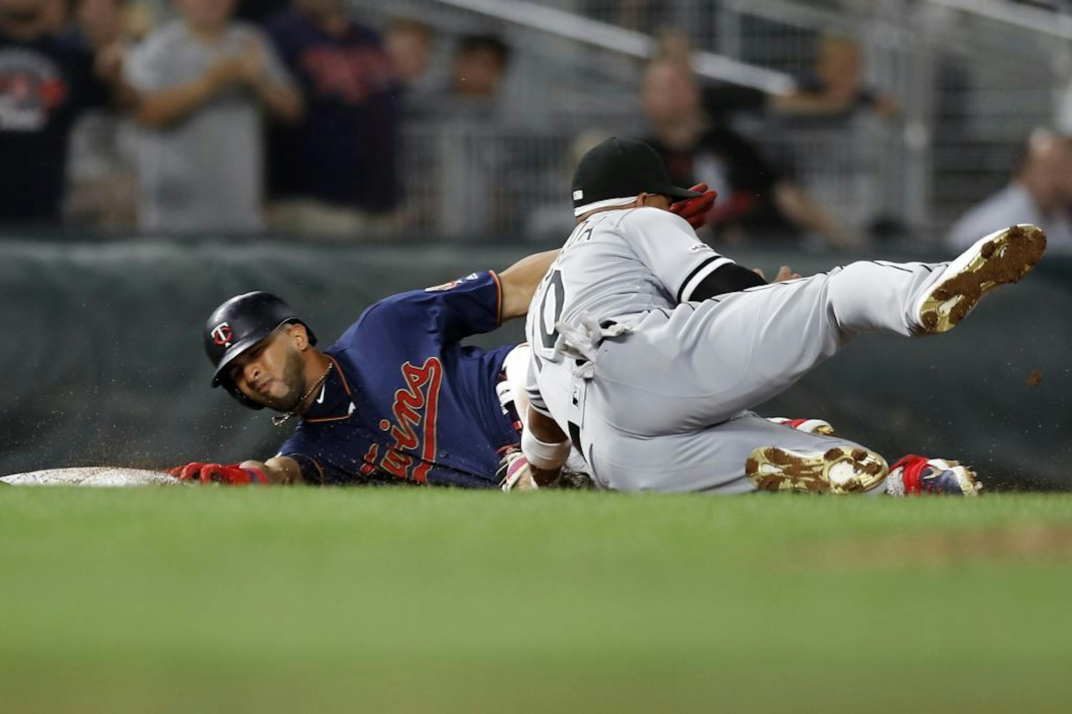 Eddie Rosario (20) was tagged out at third base by Chicago White Sox third baseman Yoan Moncada (10) when he tried to stretch a double into a triple with two outs in the eighth inning.