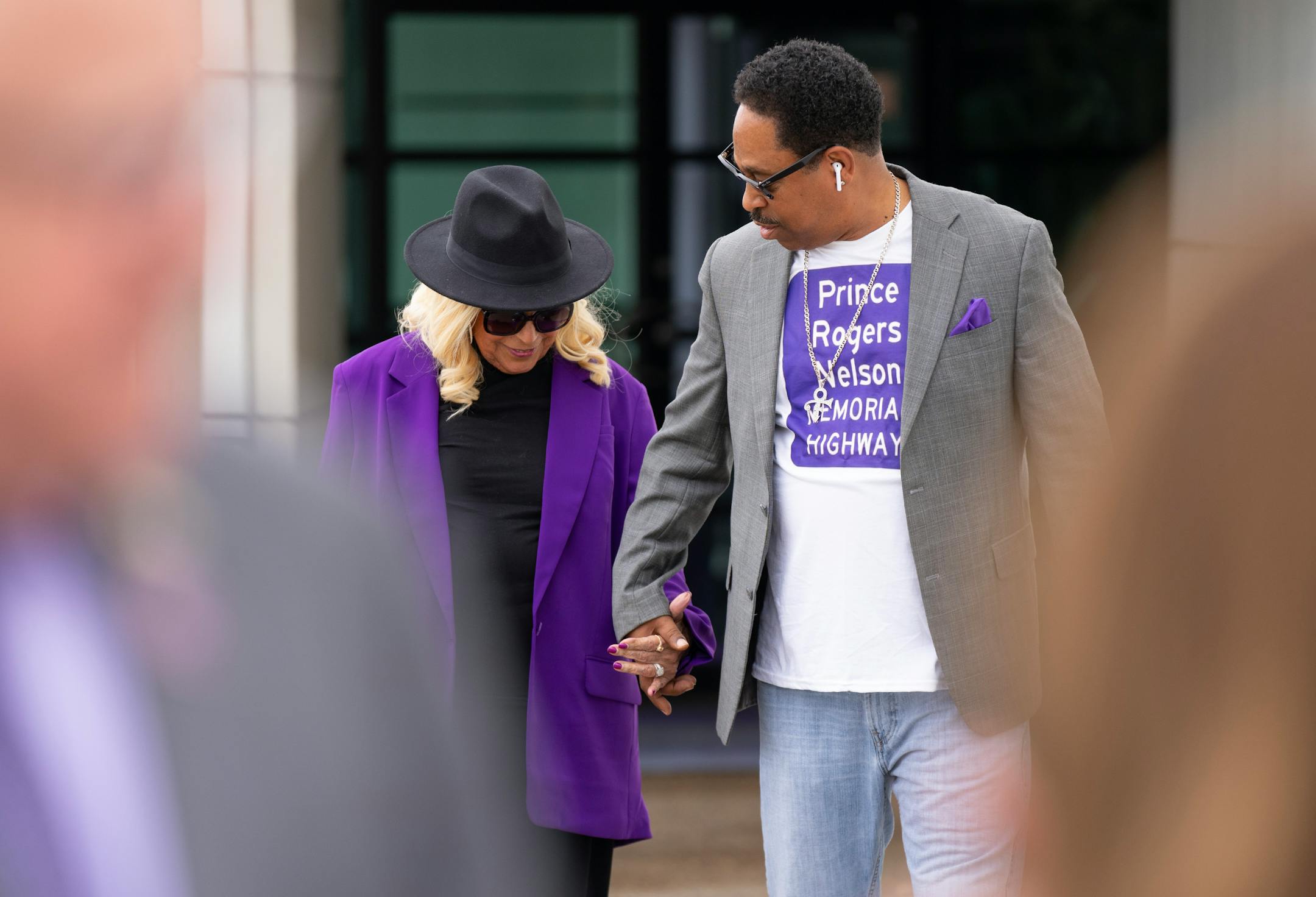 Sharon Nelson, Prince's sister, holds hands with Mark Webster, a major advocate for the bill, before Governor Tim Walz signs a bill renaming a 7-mile stretch of Highway 5 as "Prince Rogers Nelson Memorial Highway."