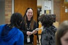 Teacher Narene Canindo greets students in her classroom at the end of a school day inside Fridley Middle School.