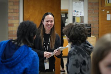 Teacher Narene Canindo greets students in her classroom at the end of a school day inside Fridley Middle School.