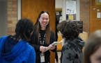 Teacher Narene Canindo greets students in her classroom at the end of a school day inside Fridley Middle School.