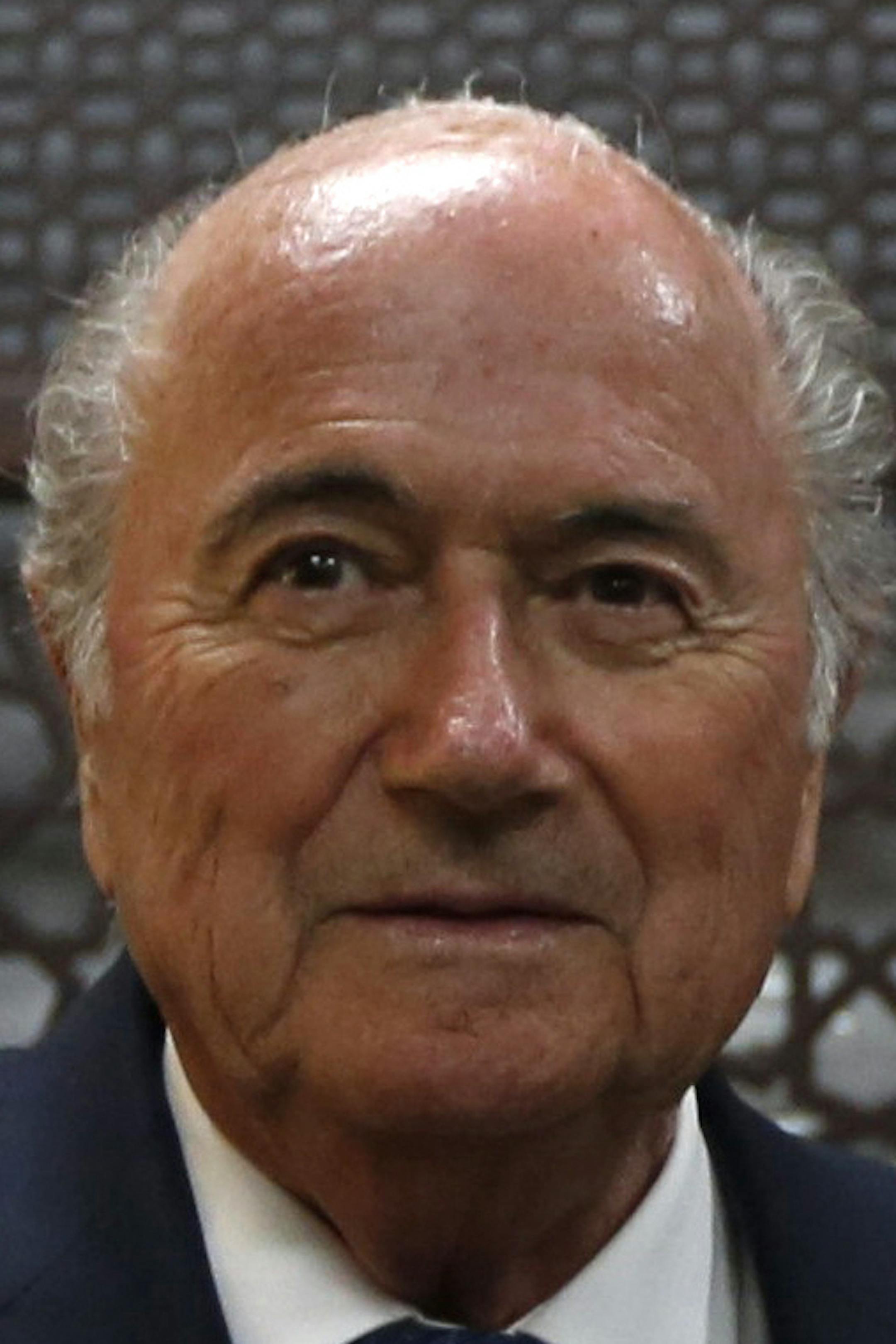 Palestinian President Mahmoud Abbas, right, receives a gift from FIFA President Sepp Blatter, during their meeting in the West Bank city of Ramallah, Wednesday, May 20, 2015. FIFA President Sepp Blatter said Tuesday he is on a "mission of peace" to resolve tensions between the Israeli and Palestinian soccer federations in the hope of staving off a Palestinian bid to oust Israel from the world governing body. (Mohamad Torokman/ Pool Photo via AP) ORG XMIT: CAIBS101