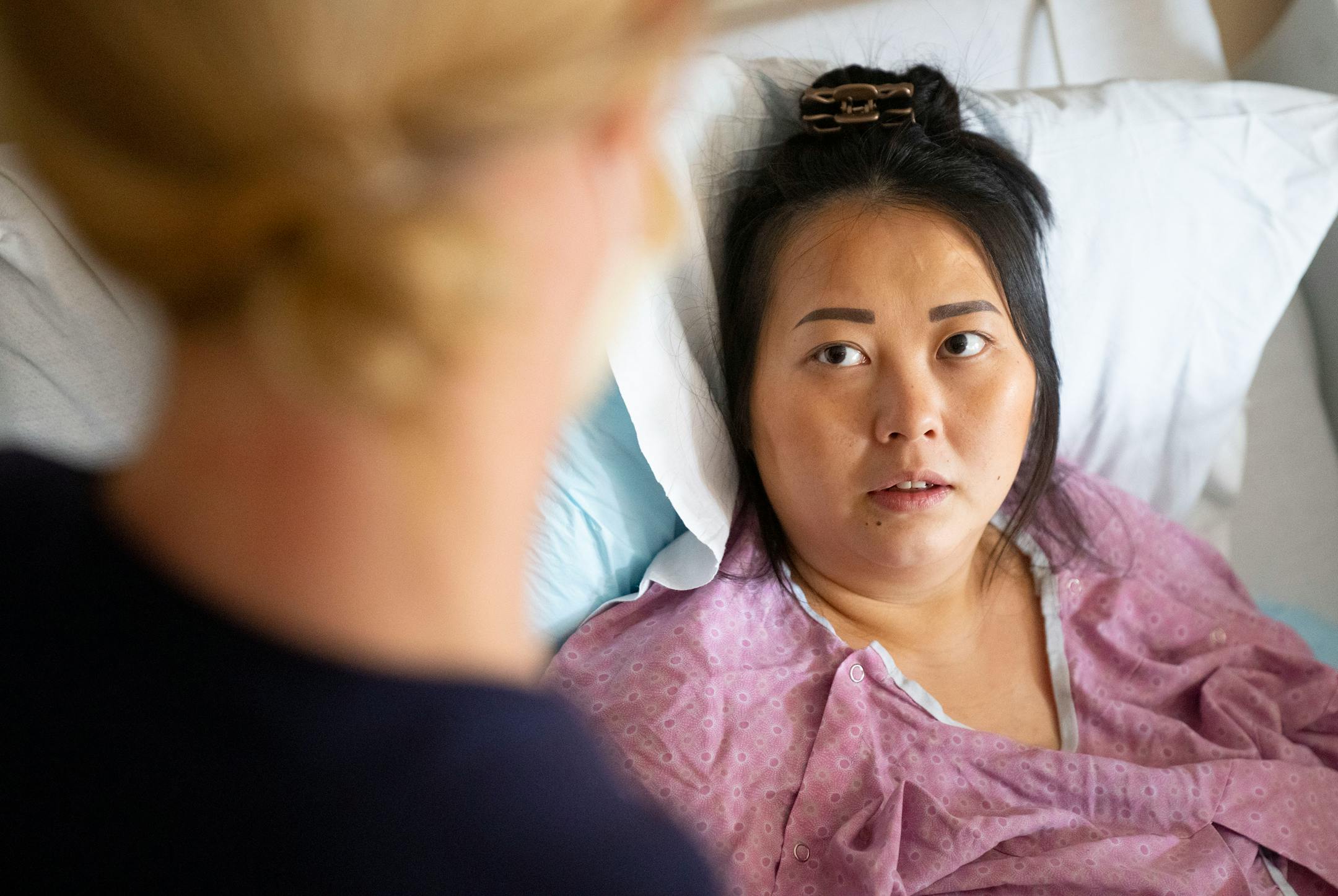 Andrea Anderson, RN, talks to Kao Her about what types of tests to expect for her newborn son, Atticus Vang, Thursday, March 24, 2022 at Maple Grove Hospital in Maple Grove, Minn.