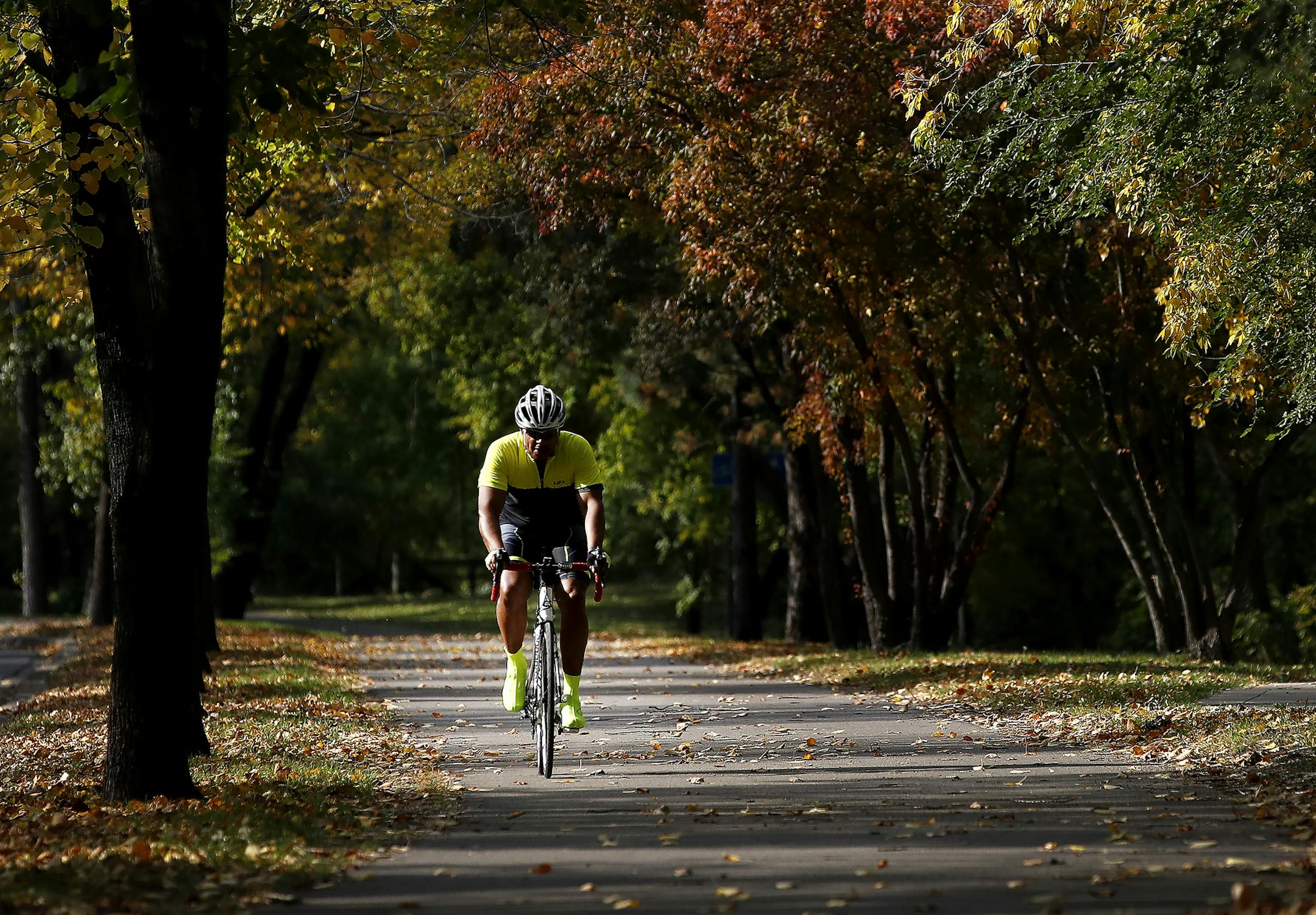 A cyclist made his way down a bike path along James I. Rice West River Parkway in Minneapolis on Tuesday. ] CARLOS GONZALEZ cgonzalez@startribune.com - October 11, 2016, Minneapolis, MN, Three fresh master plans for regional parks in Minneapolis will add an estimated $7 million in operating costs over the next 25 years, a 35 percent increase over now.