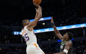 Suns forward Kevin Durant shoots over Wolves guard Anthony Edwards on March 28 at Target Center. Edwards has great admiration for Durant, who might be