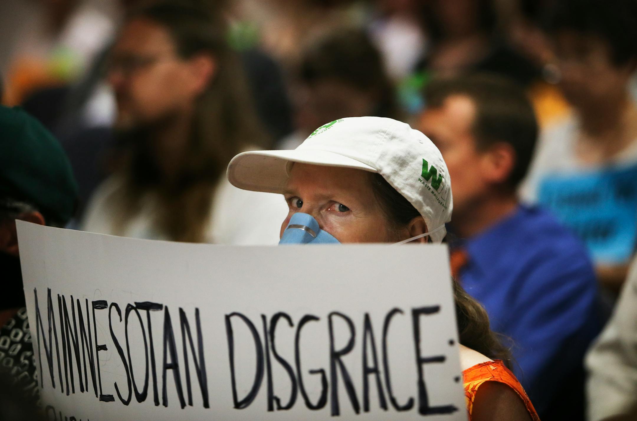 Connie Bonniwell of Robbinsdale, who suffers from multiple chemical sensitivity, held a sign that called using Canadian tar sand crude oil a "Minnesotan Disgrace" during the Public Utilities Commission meeting Wednesday, July 17, 2013, in St. Paul.