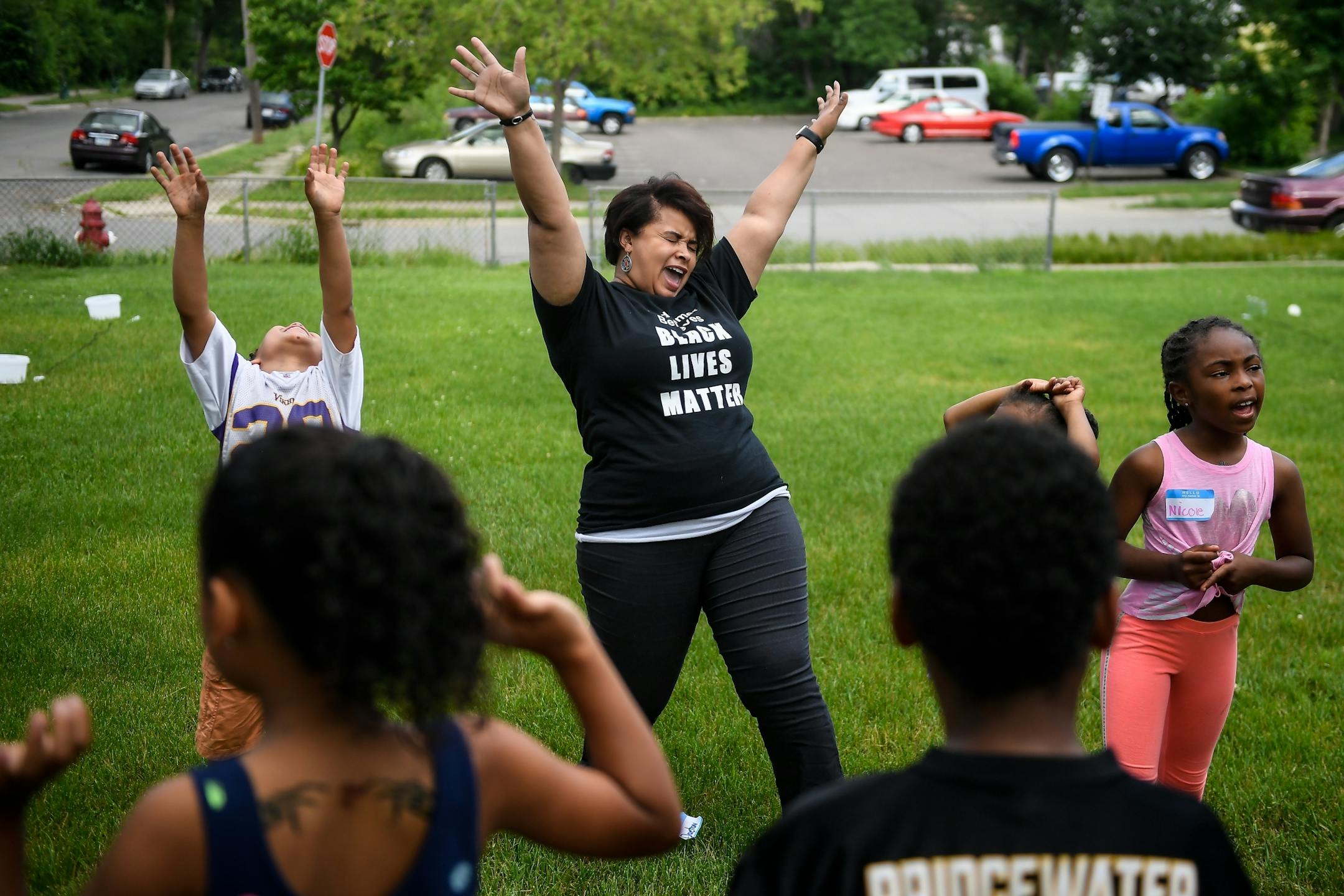 Redeemer Lutheran Church associate director of community engagement Jia Brown, of Apple Valley, sang "Boom Chicka Boom" with campers before a community cookout Wednesday night.