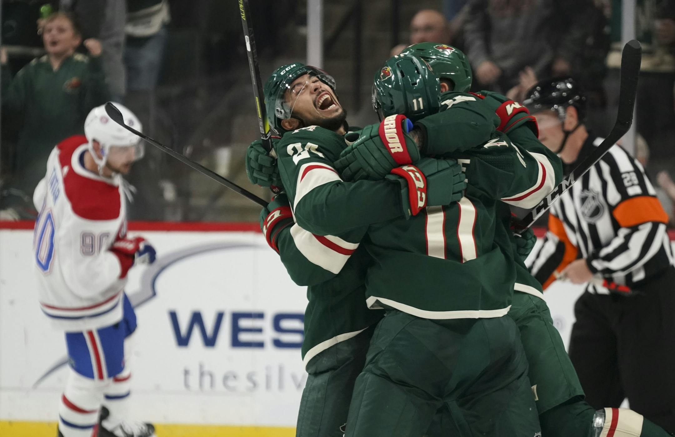 Minnesota Wild defenseman Matt Dumba (24) and left wing Jason Zucker (16) celebrated with Zach Parise (11) after he scored what proved to be the game winner in the third period.