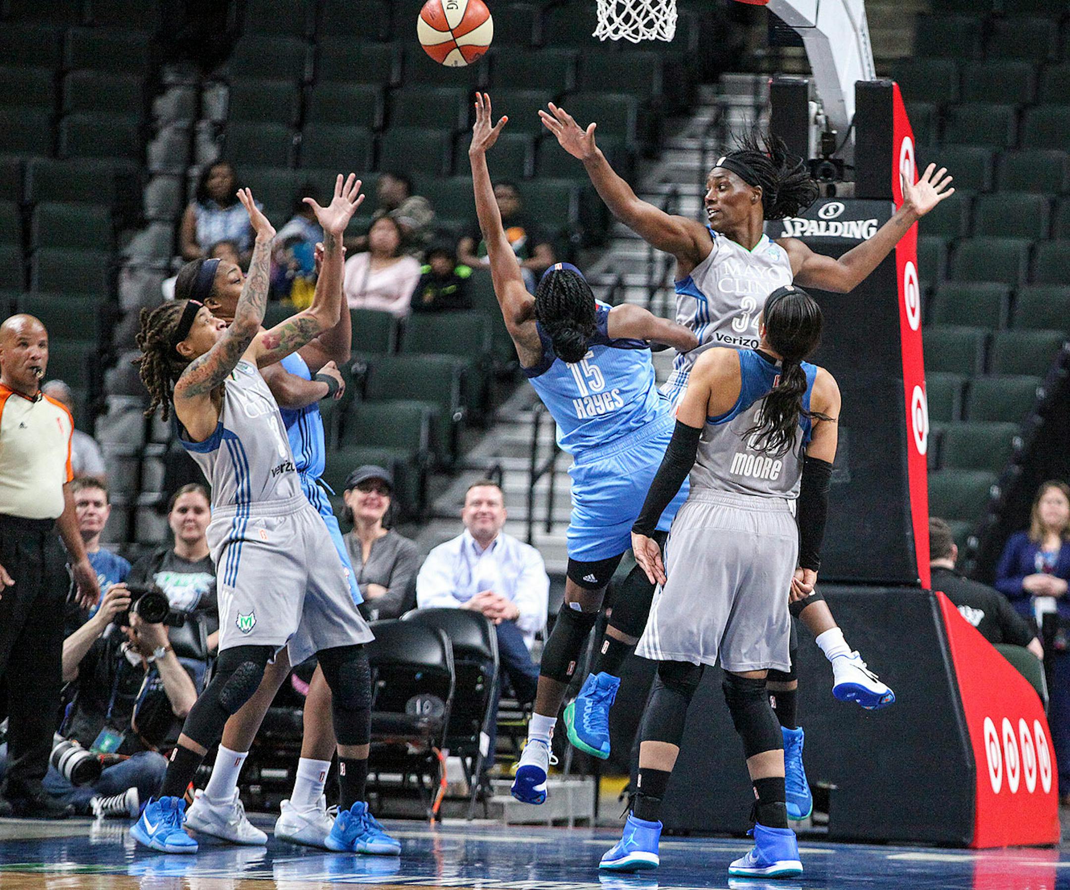 Minnesota Lynx center Sylvia Fowles, tries to block a shot by Atlanta Dream guard Tiffany Hayes, in the first period.