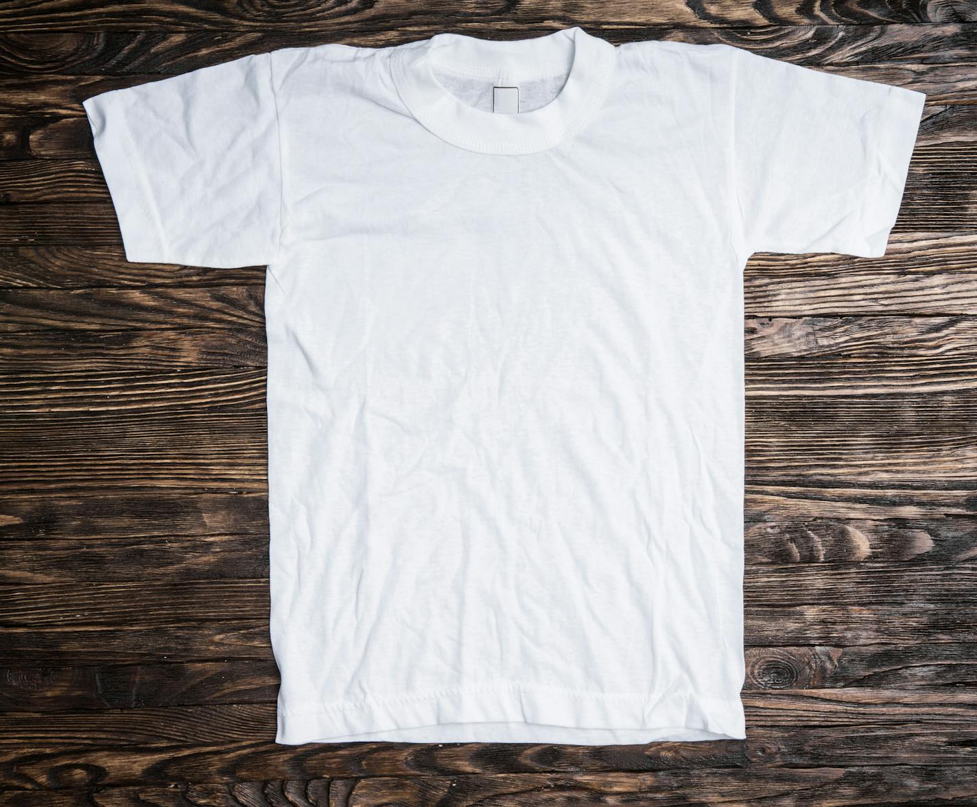 white cotton t-shirt on wooden background
istock