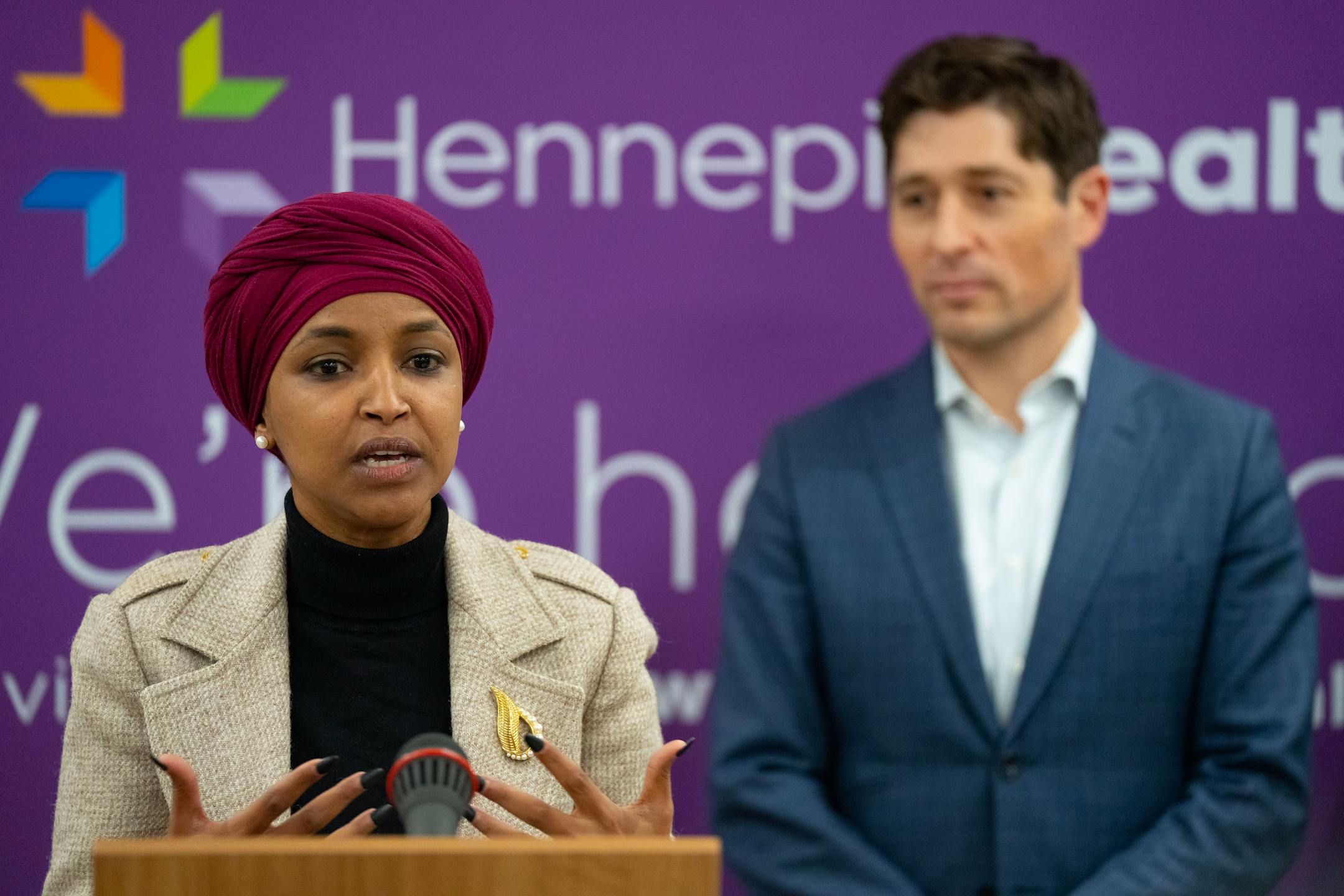 U.S. Representative Ilhan Omar, flanked by Minneapolis Mayor Jacob Frey, speaks at a press conference regarding the Next Step Program Tuesday, Jan. 17, 2023 at Hennepin County Medical Center in Minneapolis ]