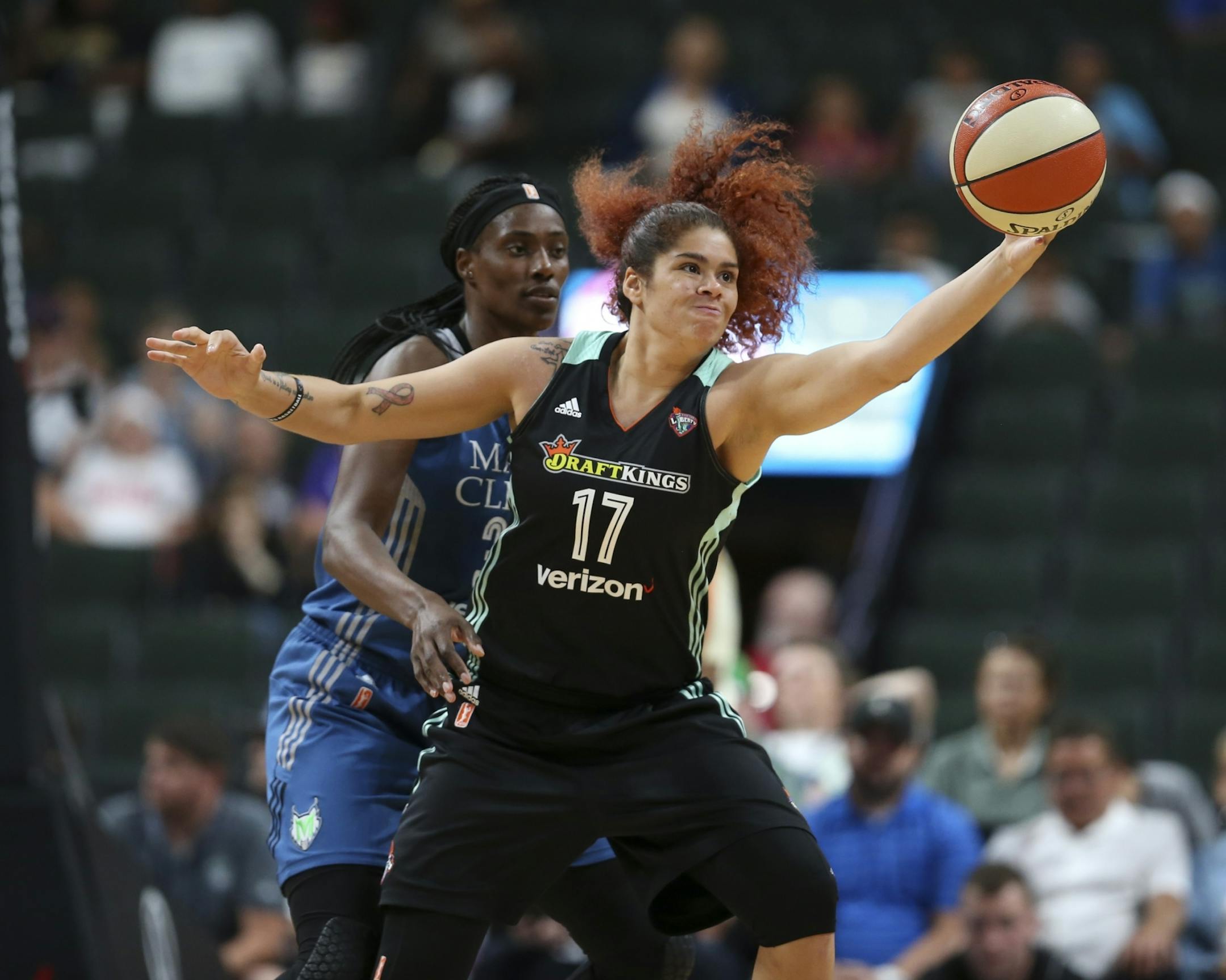 Former Gopher, New York Liberty center Amanda Zahui B. (17) reached for a pass while defended by Minnesota Lynx center Sylvia Fowles (34) in the second quarter.