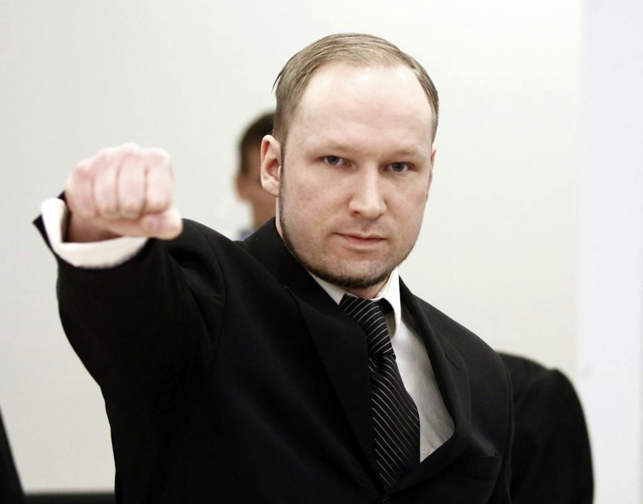 Accused Norwegian Anders Behring Breivik gestures on arrival at the courtroom, in Oslo, Norway, Wednesday April 18, 2012.