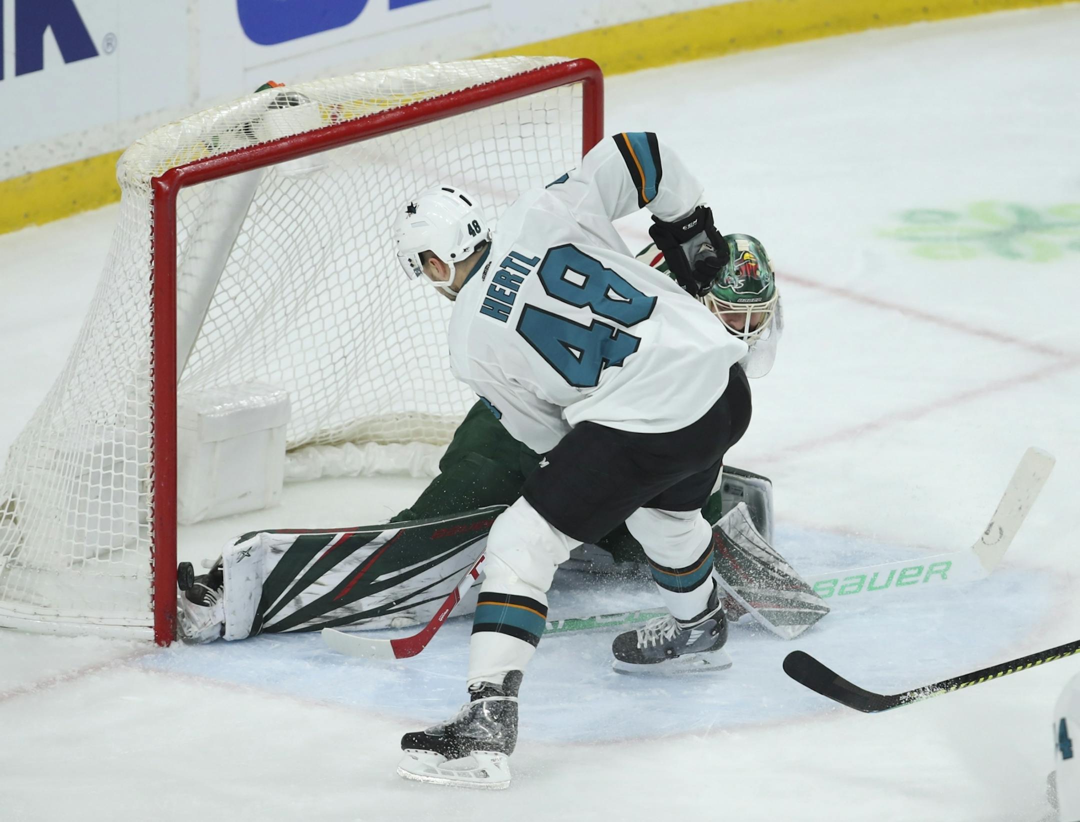San Jose Sharks center Tomas Hertl (48) slipped the puck over the skate of Minnesota Wild goaltender Devan Dubnyk (40) in the third period for San Jose's second goal of the game.