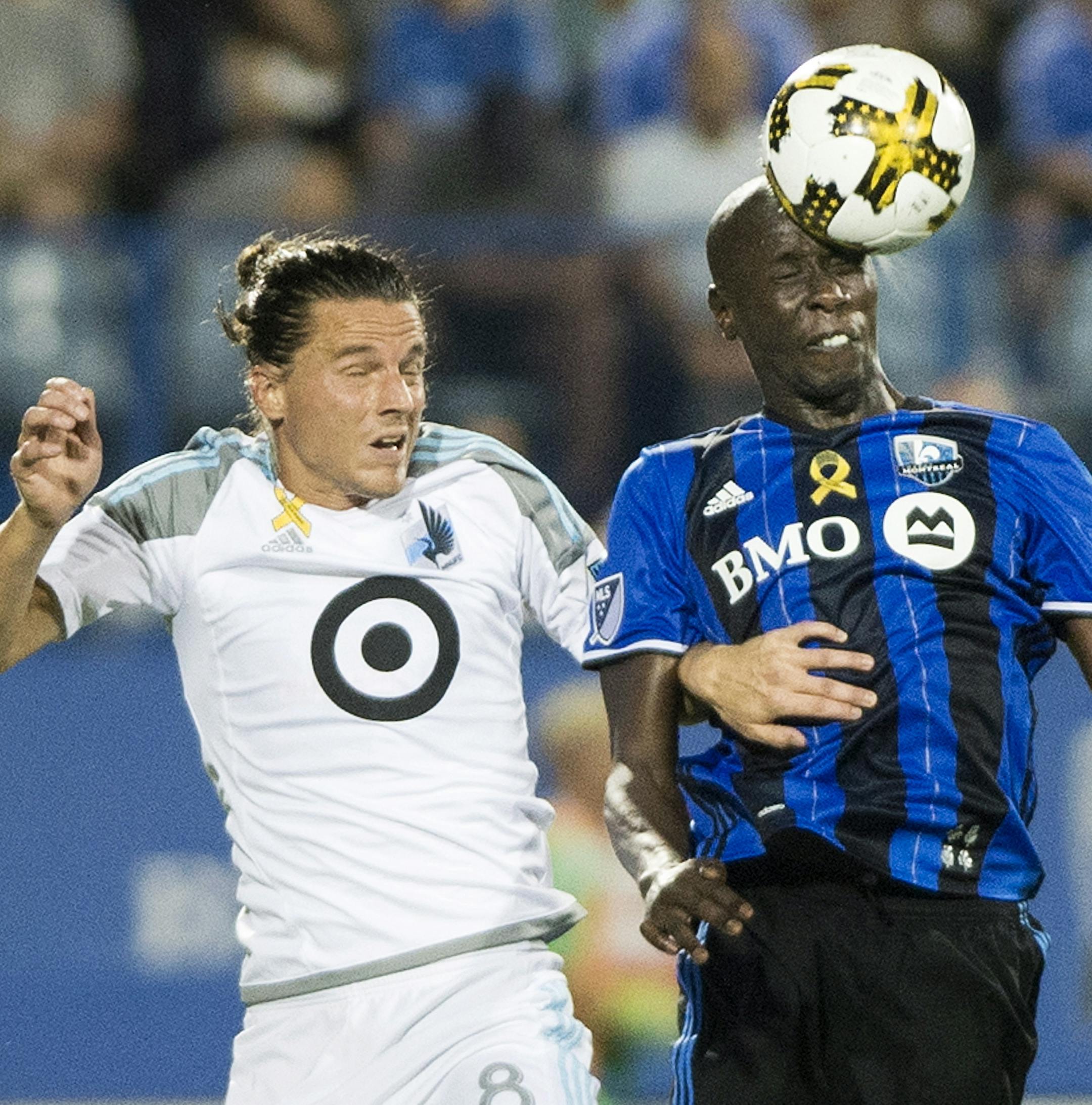 Montreal Impact's Hassoun Camara, right, challenges Minnesota United FC's Marc Burch during second half MLS soccer action in Montreal, Saturday, Sept. 16, 2017. (Graham Hughes/The Canadian Press via AP)