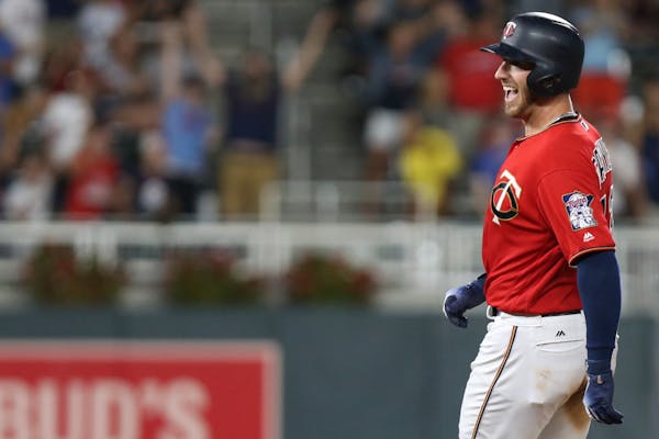Minnesota Twins' Mitch Garver smiles after hitting a fly ball to make a double in the ninth inning to win against the Cleveland Indians in a baseball 