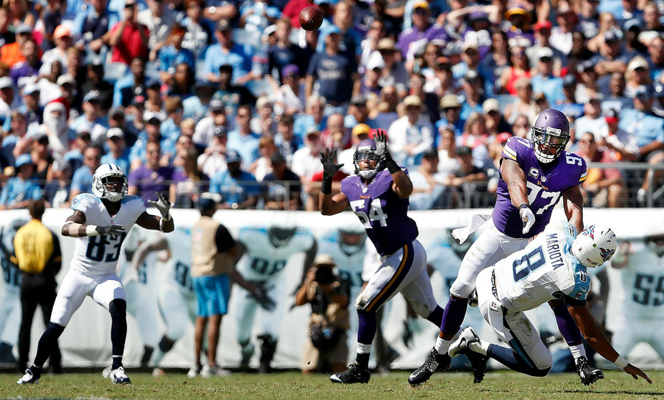 As Everson Griffen (97) applied pressure to Marcus Mariota linebacker Eric Kendricks intercepted a pass intended for Harry Douglas (83) and returned it 77-yards for a touchdown in the third quarter.