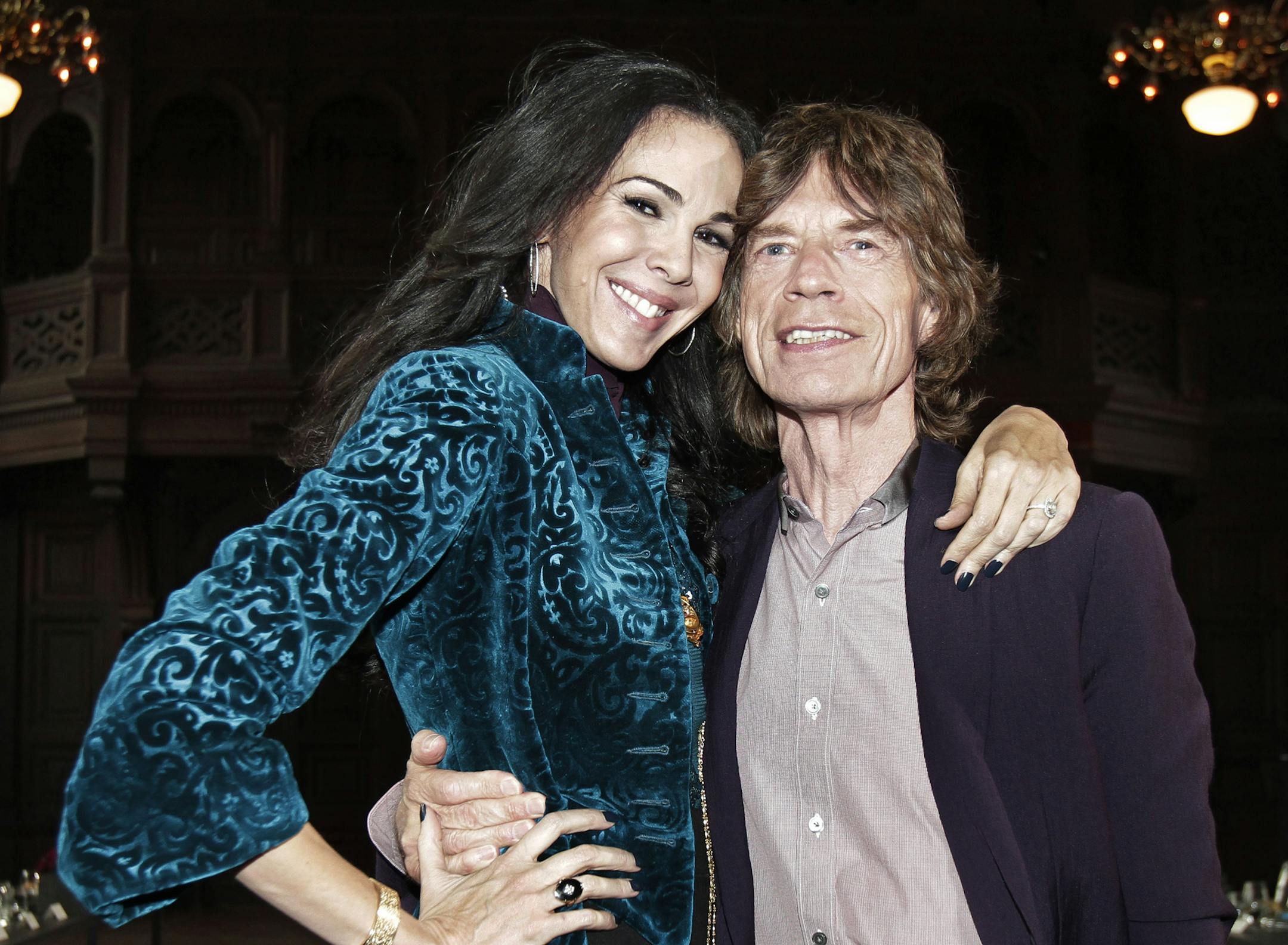 FILE - This Feb. 16, 2012 file photo shows singer Mick Jagger, right, with designer L&#x2019;Wren Scott after her Fall 2012 collection was modeled during Fashion Week, in New York. Scott, a fashion designer, was found dead Monday, March 17, 2014, in Manhattan of a possible suicide. (AP Photo/Richard Drew, File)