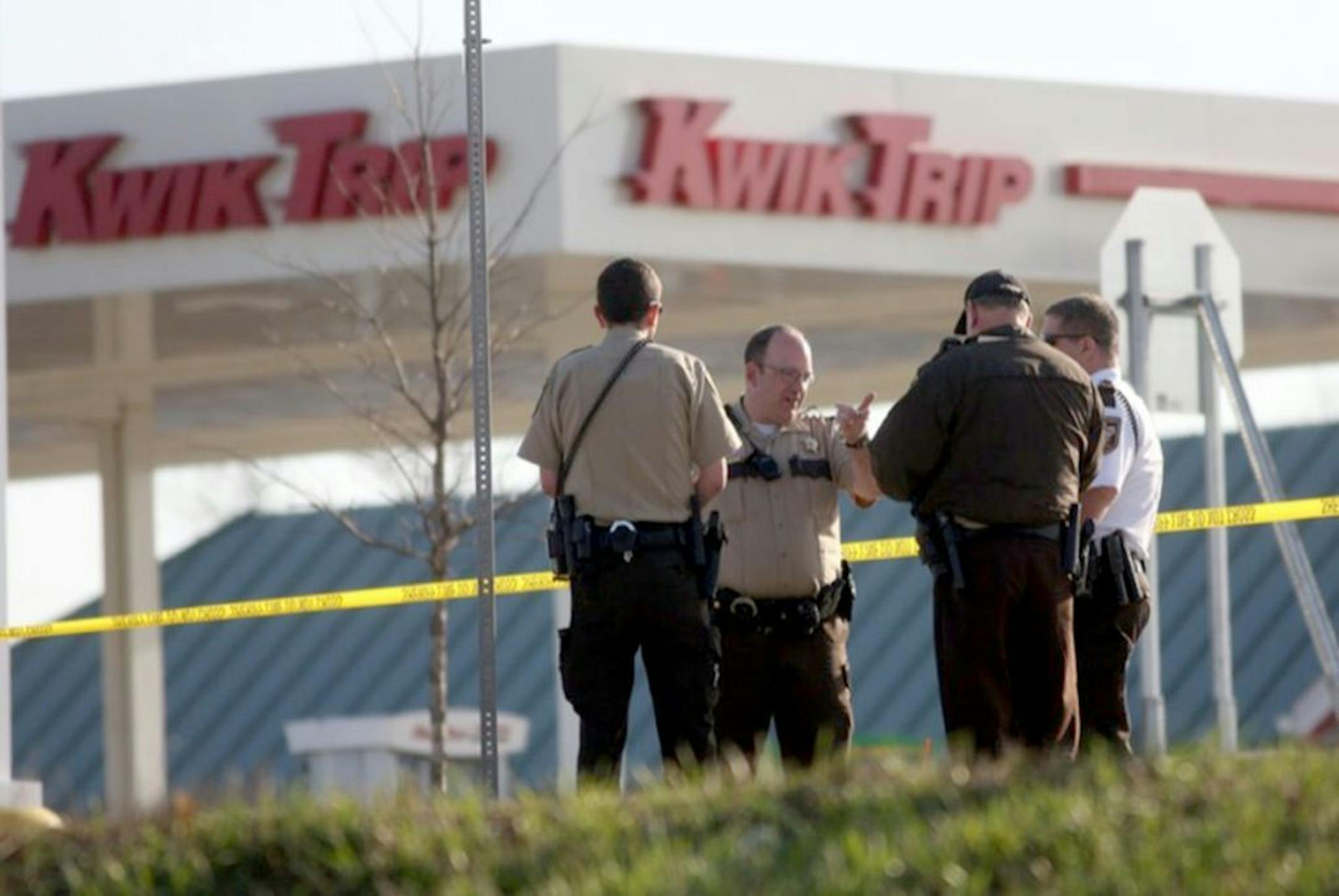 Investigators at the scene of an early morning shooting at a gas station in Norwodd- Young America that wounded a deputy sheriff.