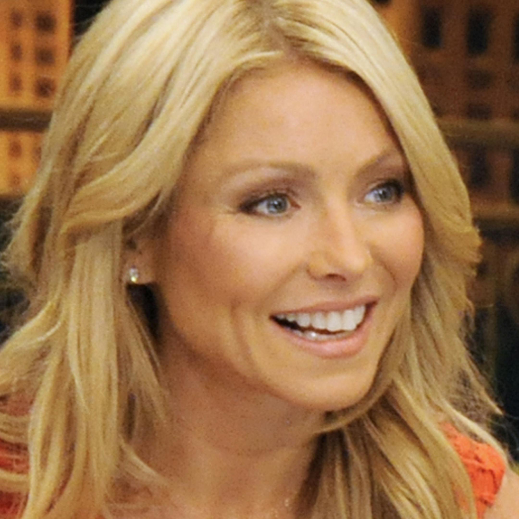 This undated photo shows former football player Michael Strahan, right, and host Kelly Ripa during Strahan's guest-host appearance on "Live! with Kelly," earlier this year in New York. Strahan is getting a permanent job in morning television as Kelly Ripa's co-host. Strahan replaces Regis Philbin on the syndicated "Live! With Kelly" show, adding his name to the title. The gap-toothed former New York Giant is currently a host of "Fox NFL Sunday." He was one of several men to get tryouts with Ripa