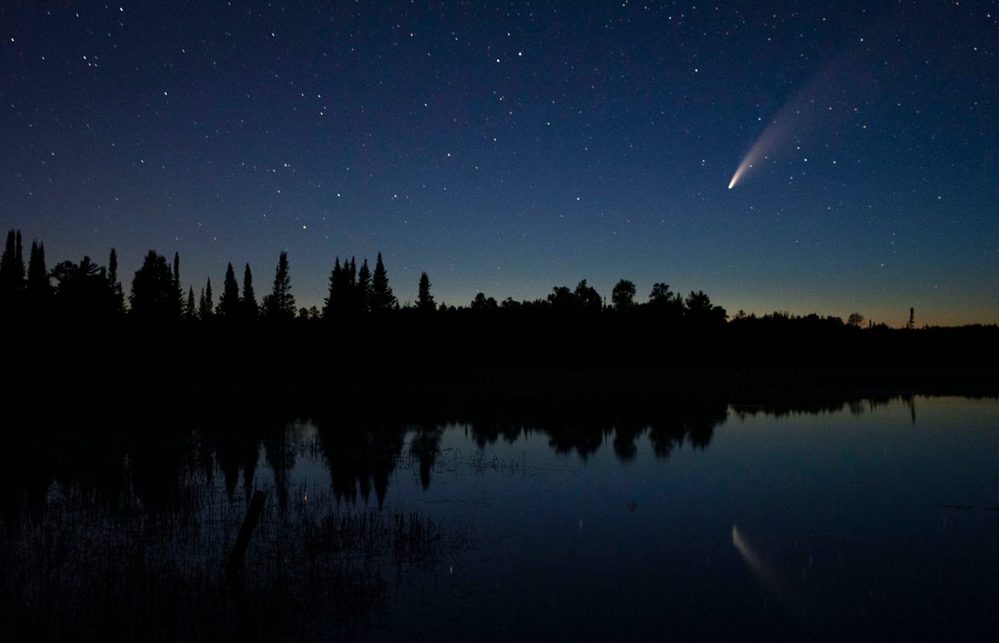 Comet Neowise in the night sky over Wolf Lake in Brimson, Minn., on July 14.