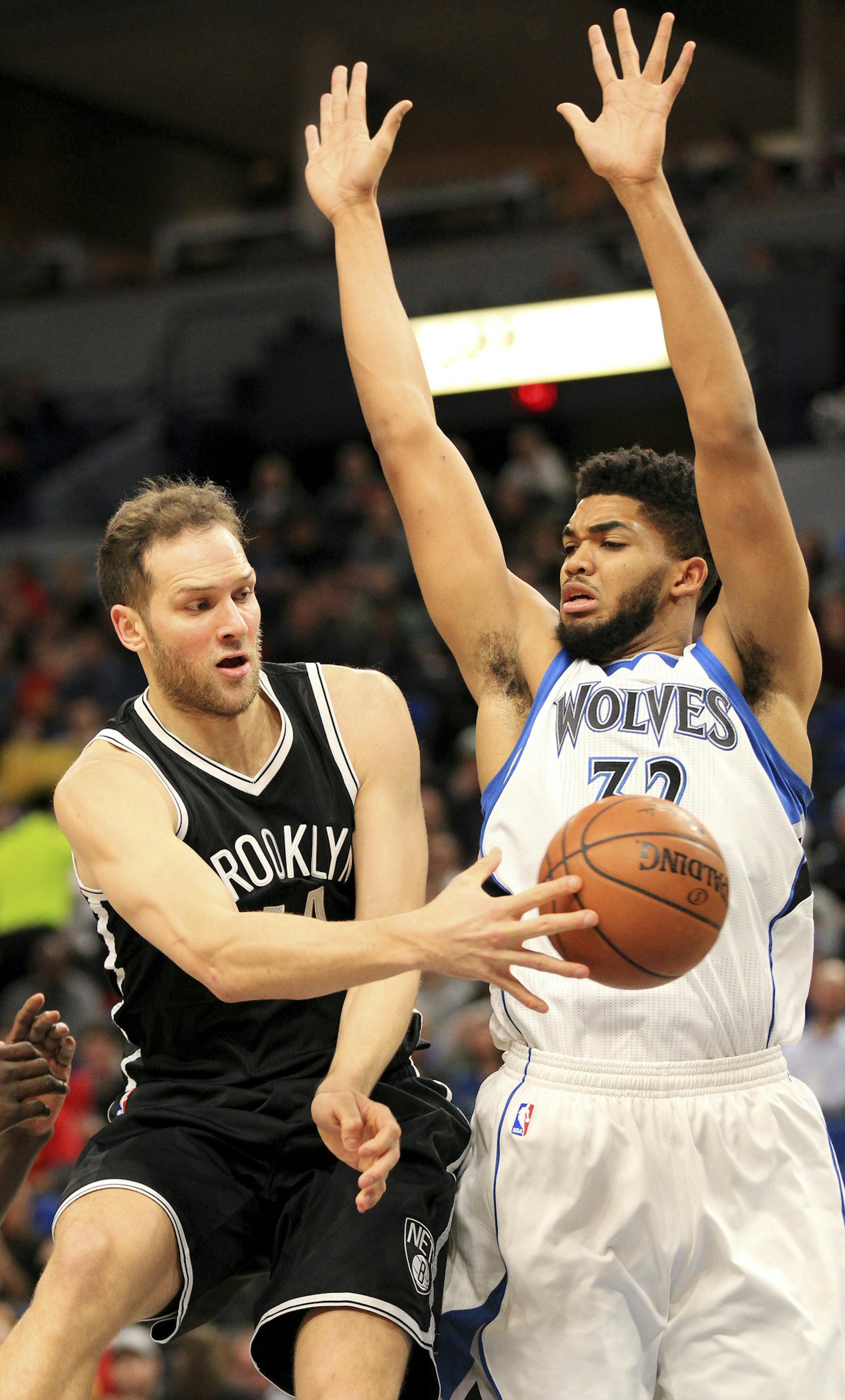 Minnesota Timberwolves center Karl-Anthony Towns (32) defends on a pass from Brooklyn Nets forward Bojan Bogdanovic (44) during the first quarter of an NBA basketball in Minneapolis, Saturday, Jan. 28, 2017. (AP Photo/Andy Clayton-King)