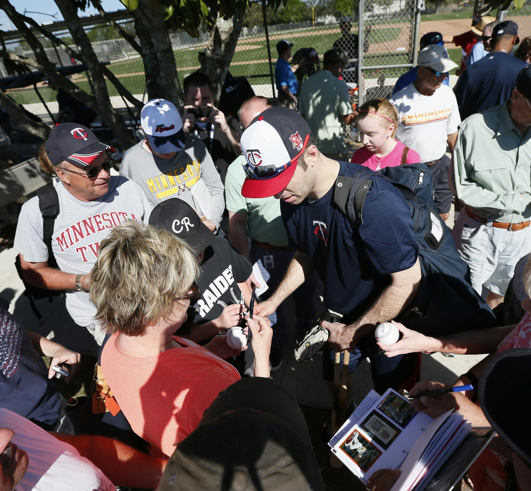 Twins first baseman Joe Mauer was surrounded by fans seeking autographs Tuesday Feb 17. 2014 in Fort Myers, Florida Lee County Sports Complex.. ] JERRY HOLT jerry.holt@startribune.com