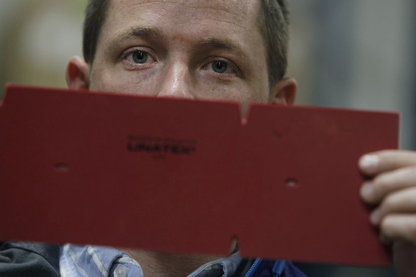 Ross Anderson, director of global operations at Midwest Rubber Service & Supply, held up a sample of the stamp they use on a Linatex rubber squeegee, which are used in large floor cleaning machines, Wednesday, October 31, 2012 in Plymouth, MN. The company was the victim of trademark infringers who knocked off its very durable squeegee rubber products with cheap fakes. As a result, roughly 50 percent of the family owned business was impacted. Small company is now fighting back with attorneys arou