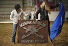 Two members of the Minneapolis Mounted Police Foundation presented the unit with a sign for the stable during the ceremony. They are, Julie Woods, lef