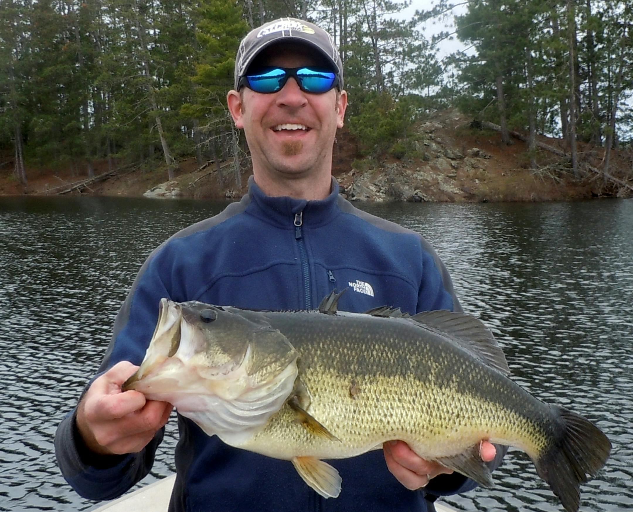 Chris Daleiden, Edina, with a 22-inch largemouth bass he caught on Basswood Lake in the BWCA.