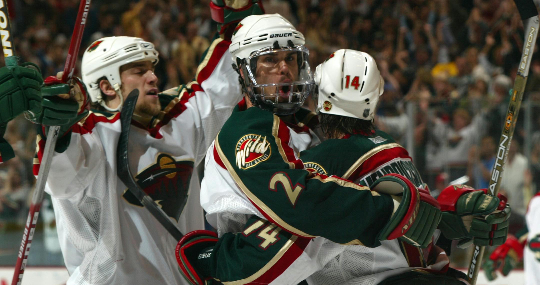 St. Paul, MN - May 7, 2003 - Wild vs Vancouver - Wild celebrate yet another goal. /// published caption 5/8/03: Nick Schultz, Willie Mitchell (2), and Darby Hendrickson (14) celebrate after Hendrickson's goal gave the Wild a 3-0 lead in the third period. The goal was Hendrickson's first in the postseason. ORG XMIT: MIN2013050323192905