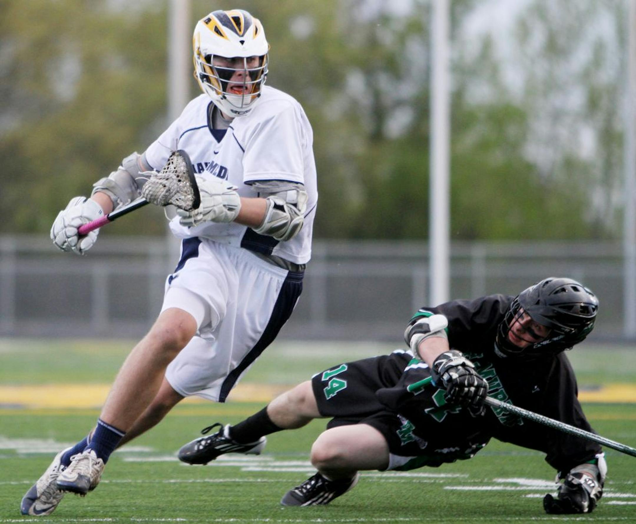 Mahtomedi midfielder Nick Lerach pushed past Hill-Murray attacker Davis Zarembinski during the Zephyrs' 12-3 victory on April 24. Photo by Marisa Wojcik • mwojcik@startribune.com