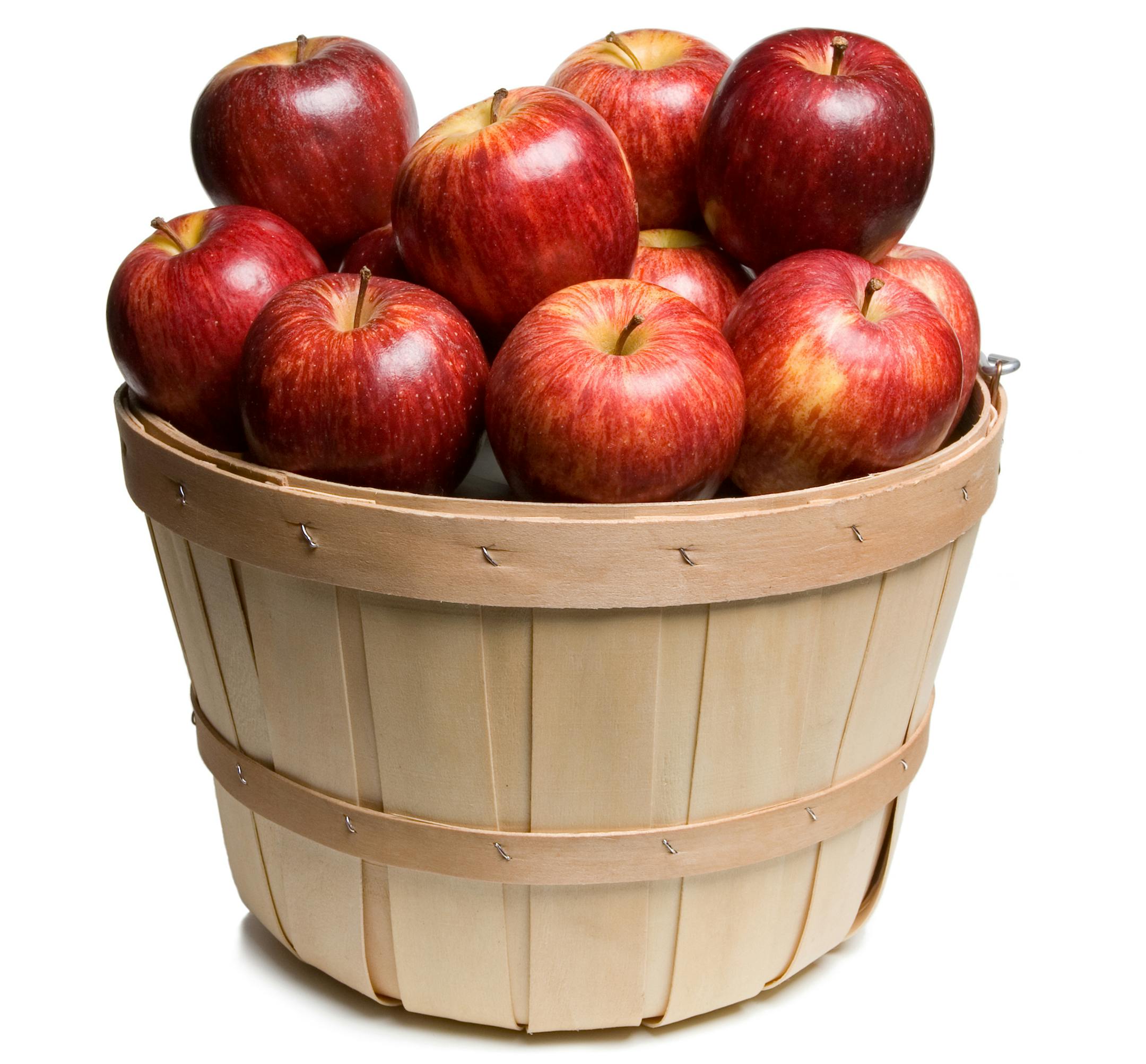 Wood basket with red apples on white background