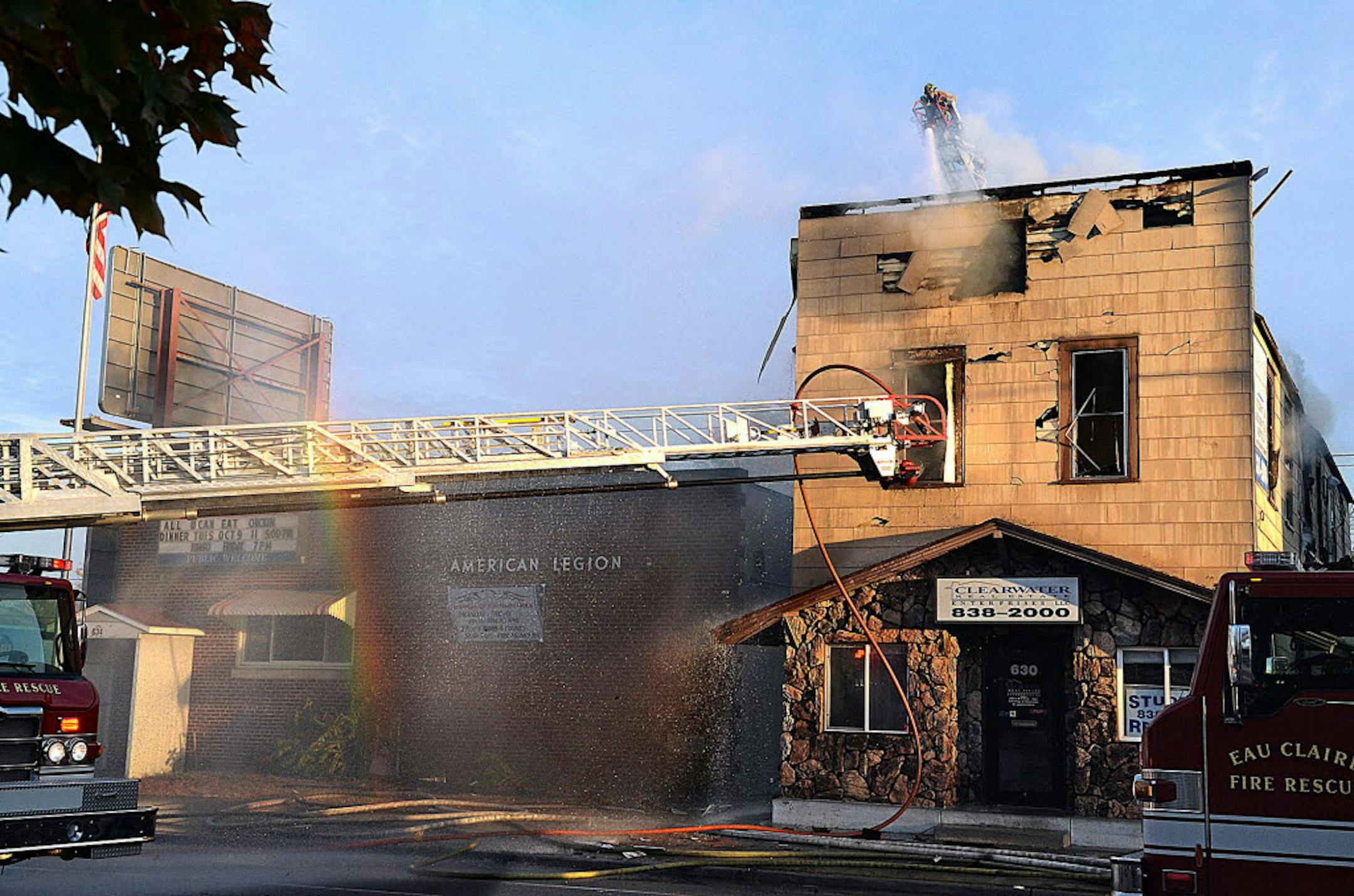 Firefighters work at the scene of an apartment fire at 630 Water St., in Eau Claire, Wis.