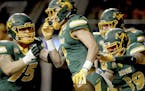 North Dakota State wide receiver Christian Watson, front, is mobbed by teammates after his long touchdown reception scores in the the first half of an