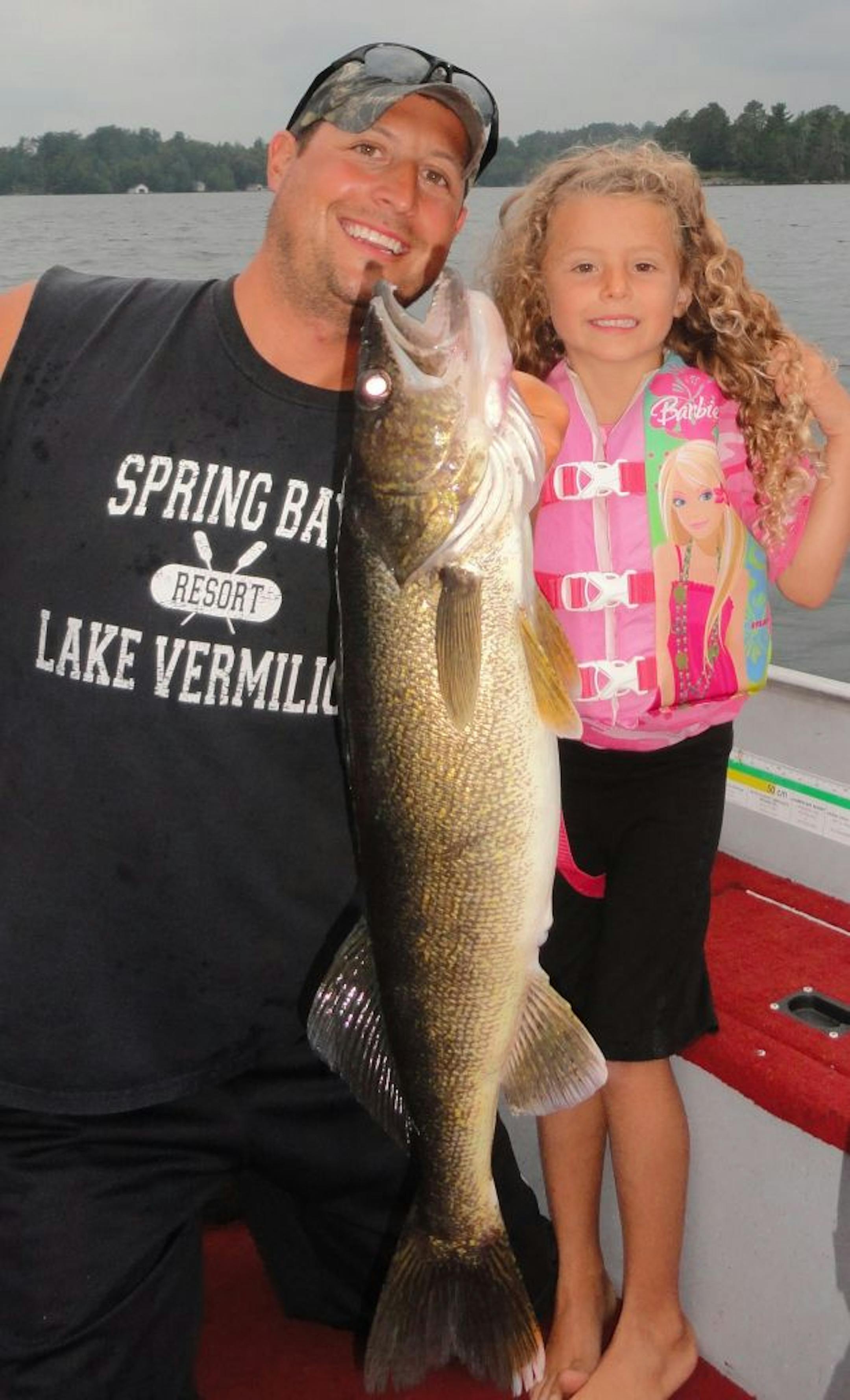 Mackenzie Jo Mjelde, 6, of Buffalo, caught this 28-inch walleye held by dad, Ross, on Lake Vermilion.