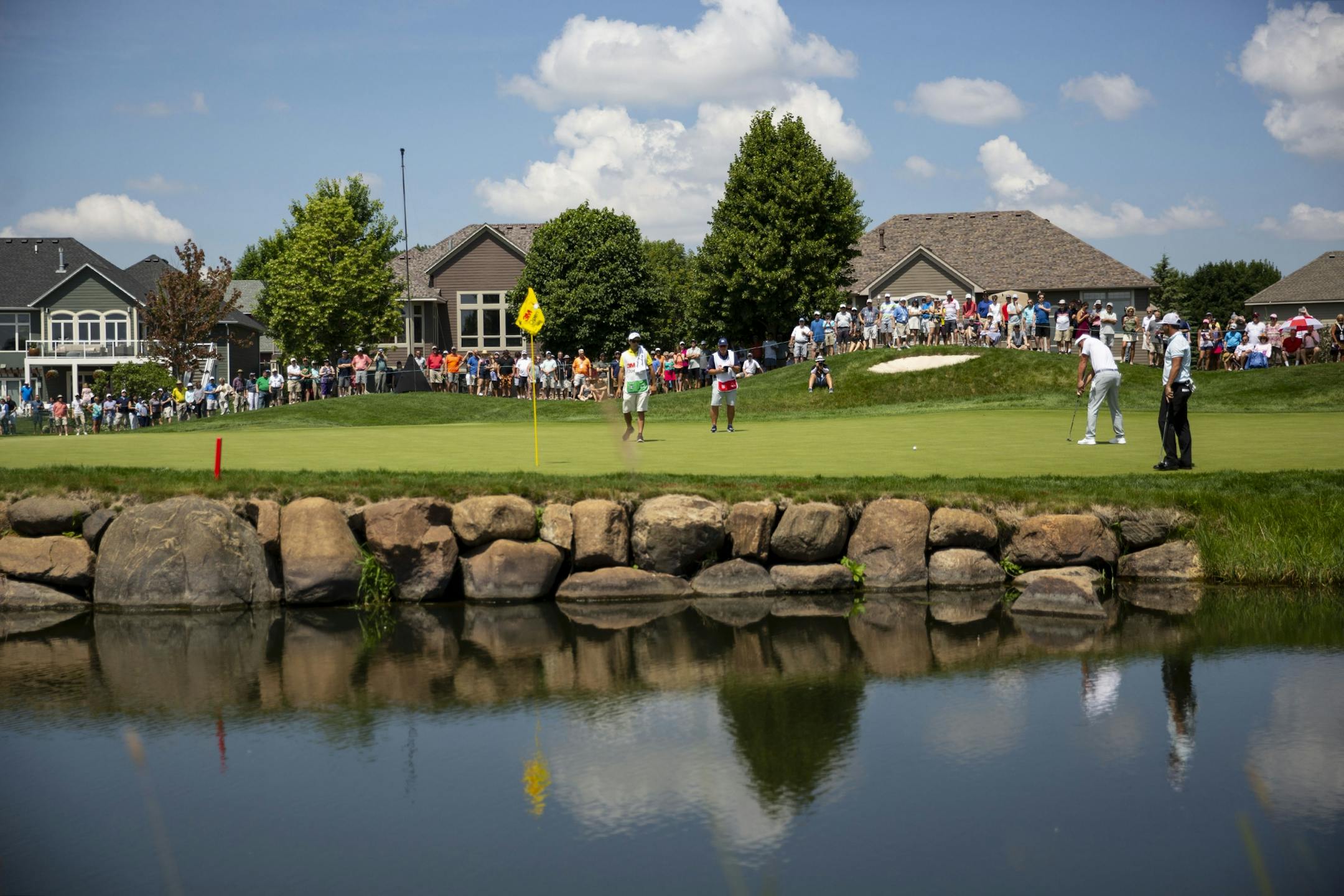 Bryson DeChambeau is reflected in a water hazard while putting on the second hole. ALEX KORMANN ¥ alex.kormann@startribune.com Competitors for the 3M Open took to the course on Saturday.
