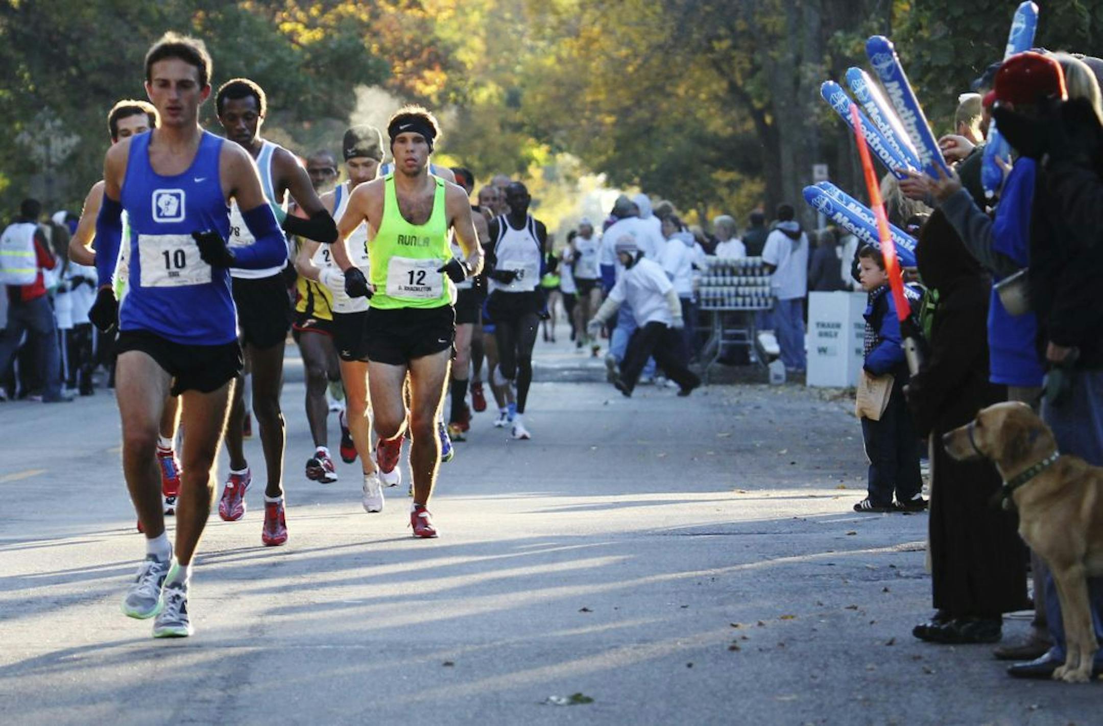 Sunny skies and crisp temps greeted Twin Cities Marathon runners and fans along the 26.2 mile route that wound its way through Minneapolis en route to the finnish in St. Paul. In this photo:] Tyler Sigl leads a pack of elite runners near the 2.5 mile mark.