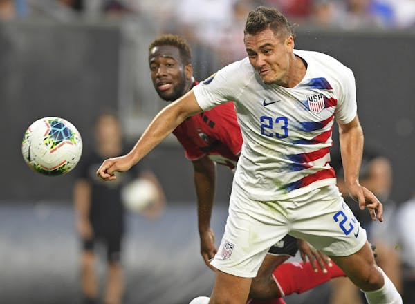 U.S. defender Aaron Long heads the ball in for a goal during the first half of the team's CONCACAF Gold Cup soccer match against Trinidad and Tobago o