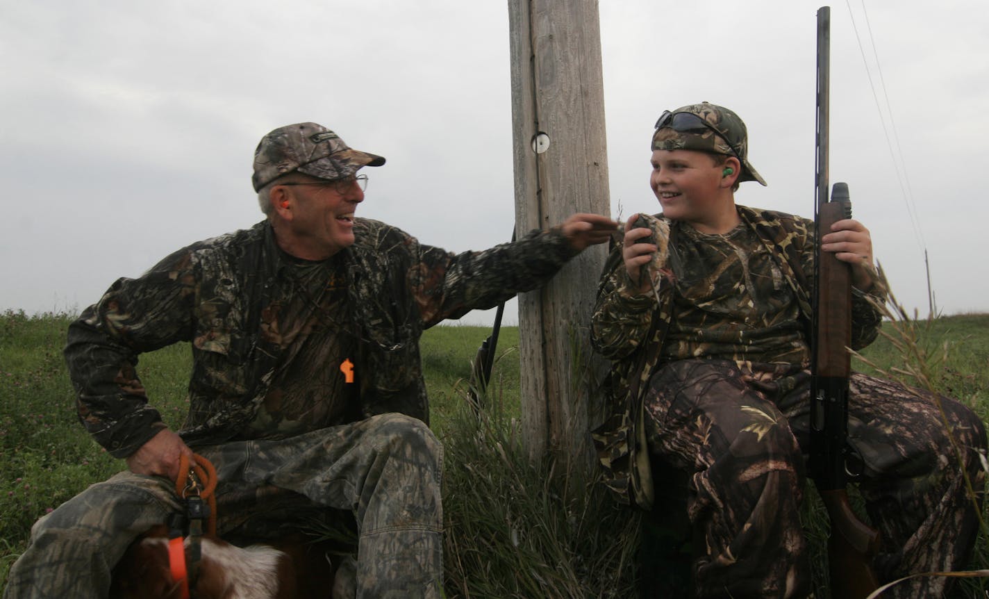 Mike Smith of Cologne, Minn., congratulated grandson Graham on bagging a mourning dove. The pair were hunting in Renville County.